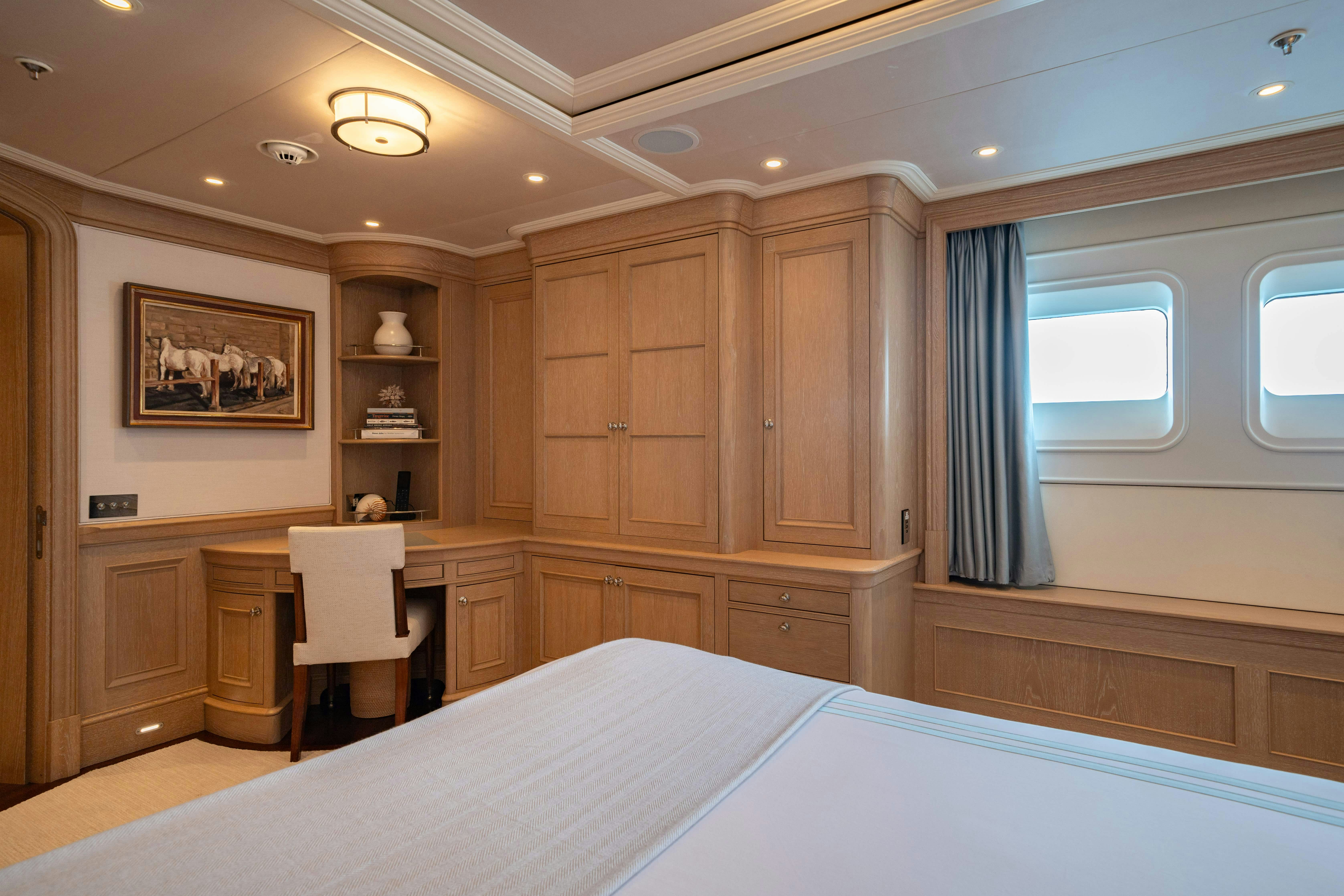 a large room with a bed and cabinets aboard FABULOUS CHARACTER Yacht for Charter