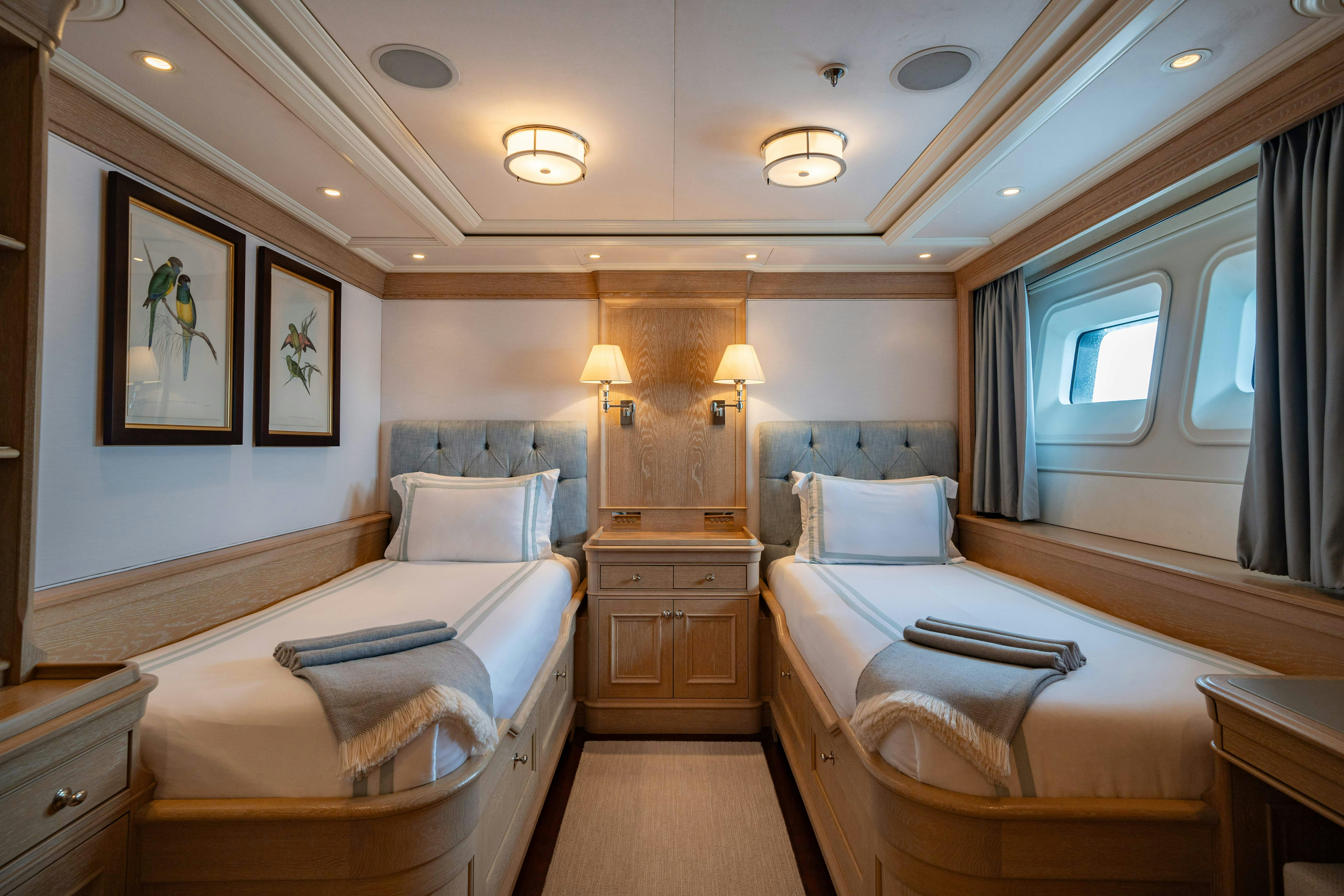 a room with a bed and a window aboard FABULOUS CHARACTER Yacht for Charter