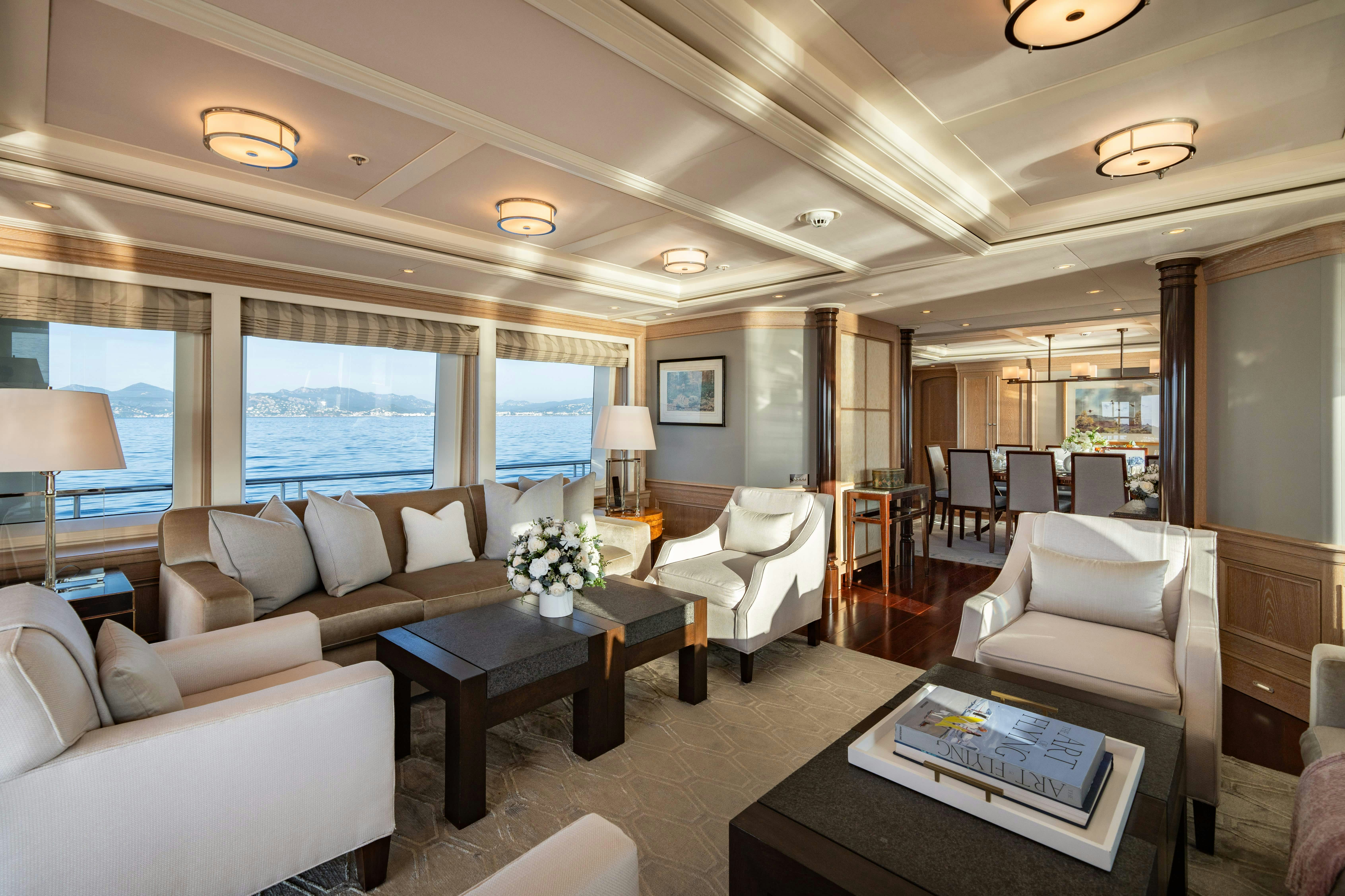 a living room with a large window aboard FABULOUS CHARACTER Yacht for Charter