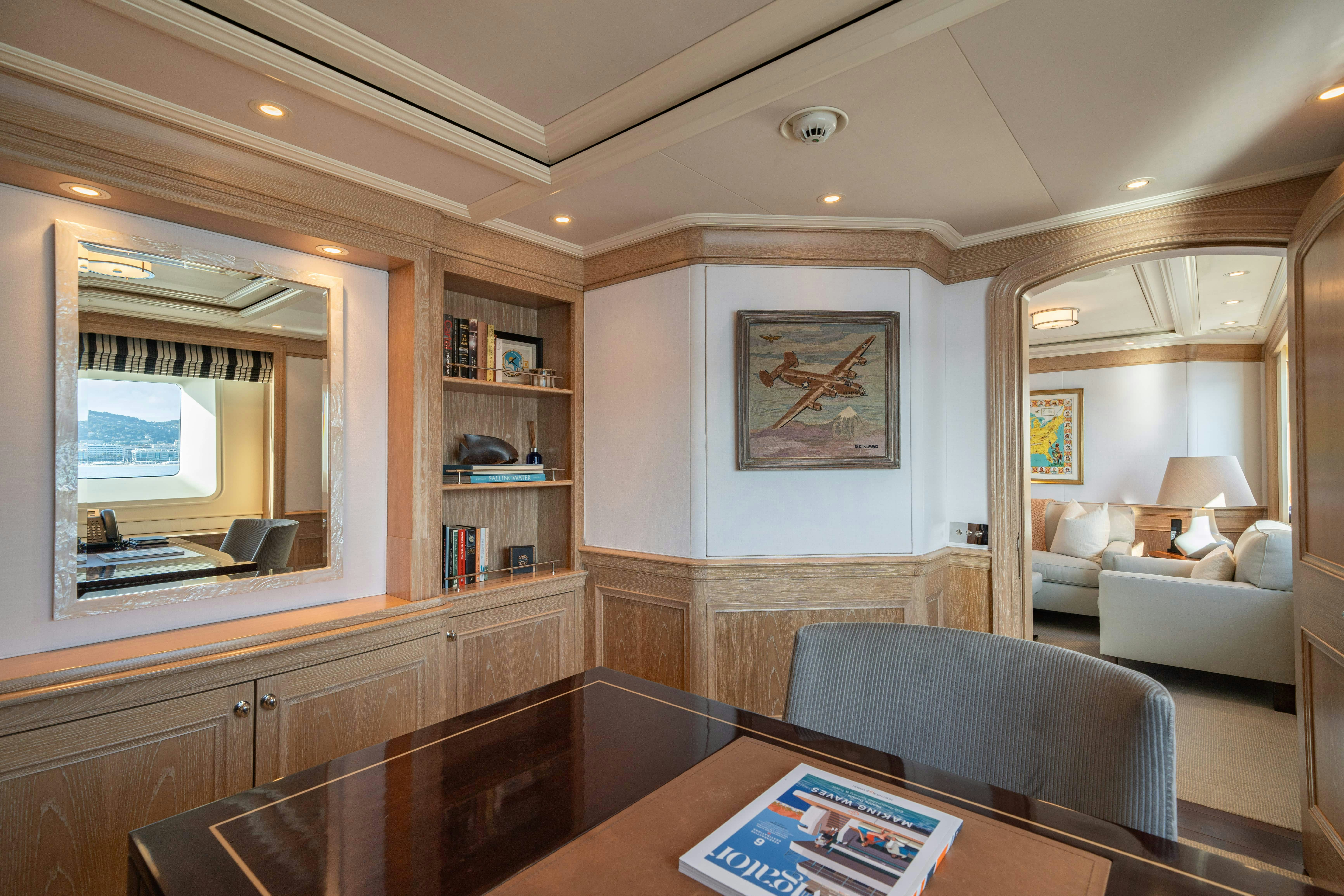 a living room with a large mirror aboard FABULOUS CHARACTER Yacht for Charter