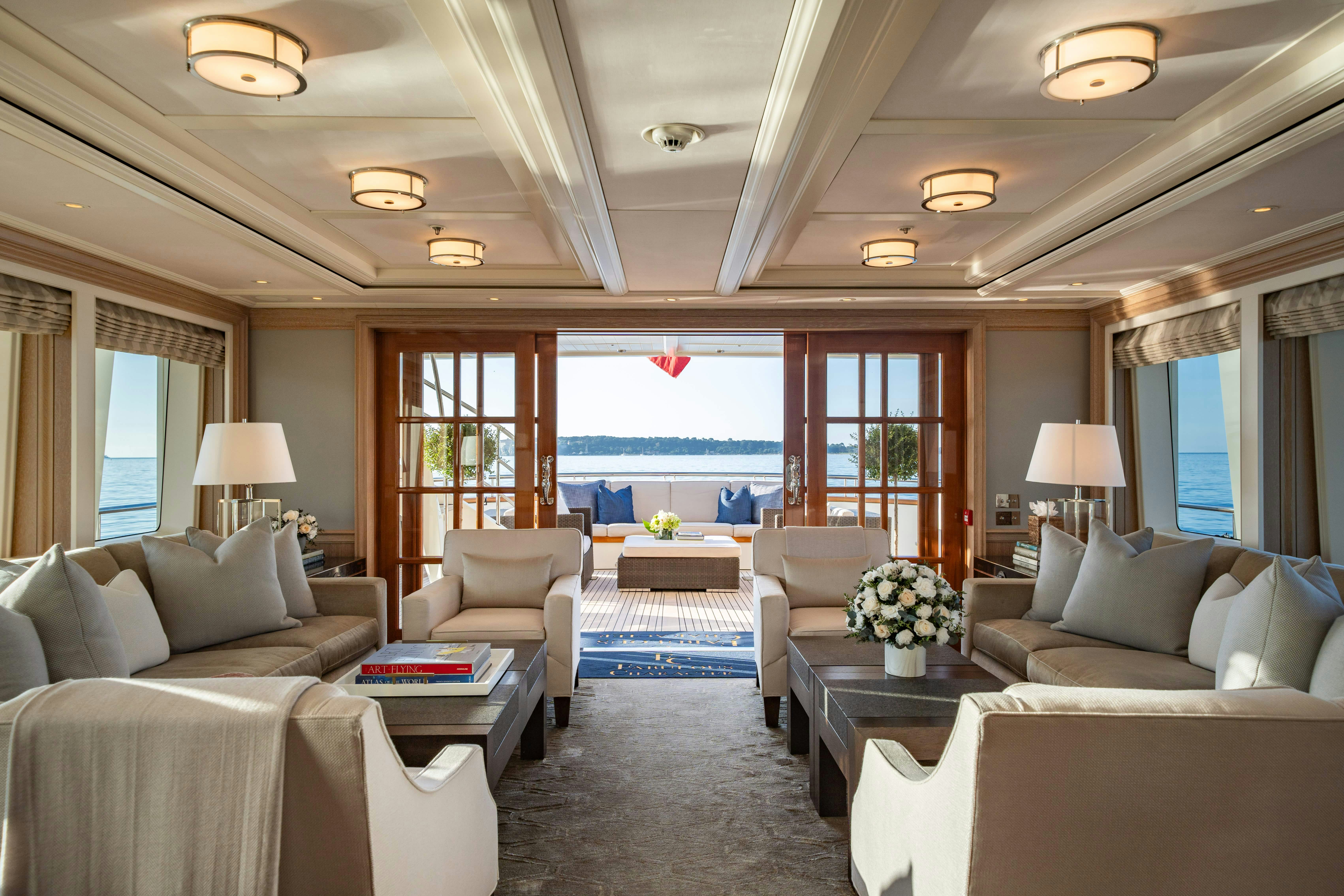 a living room with a large window aboard FABULOUS CHARACTER Yacht for Charter
