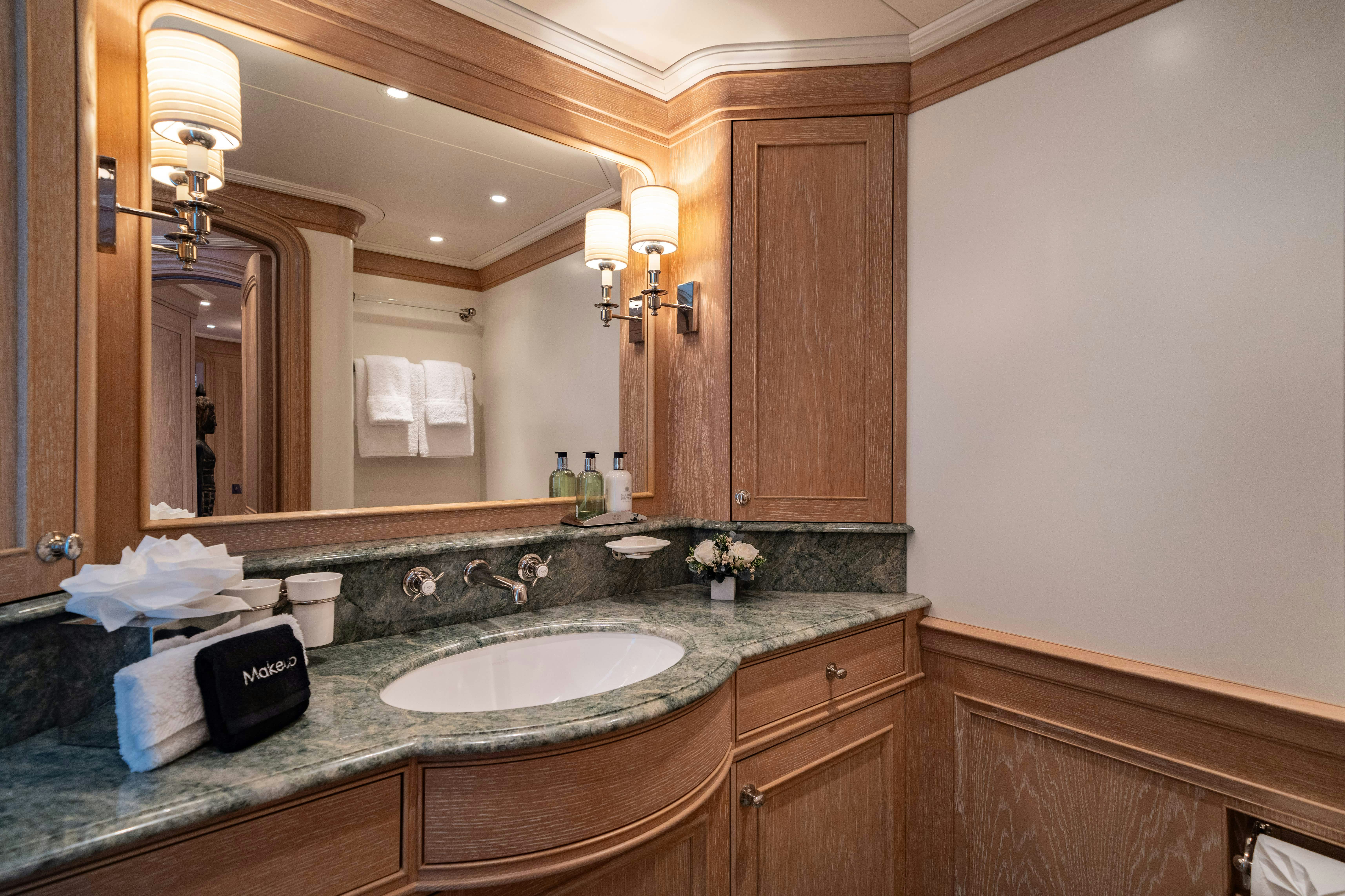 a bathroom with a large mirror aboard FABULOUS CHARACTER Yacht for Charter