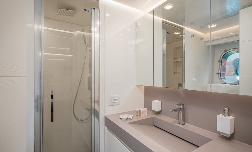 a bathroom with a large mirror aboard SANDS Yacht for Charter