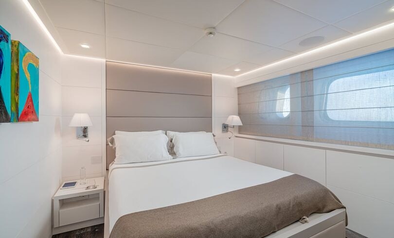 a bedroom with a large bed aboard SANDS Yacht for Charter