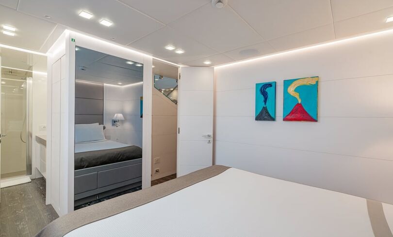 a room with a couch and a mirror aboard SANDS Yacht for Charter