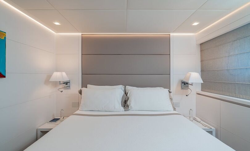a white bed with white sheets aboard SANDS Yacht for Charter