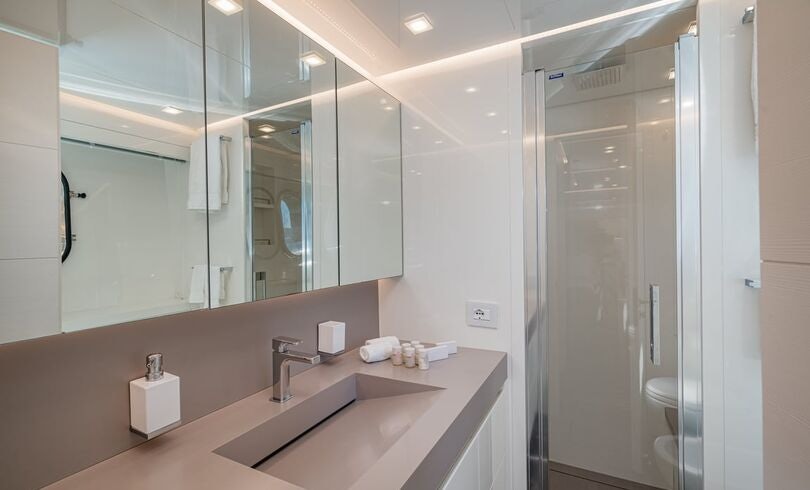 a bathroom with a large mirror aboard SANDS Yacht for Charter