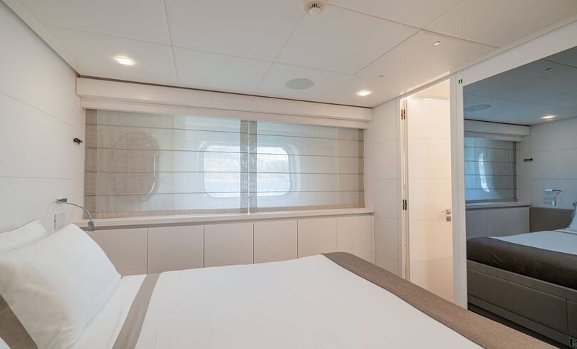 a large white bathroom with a large window aboard SANDS Yacht for Charter