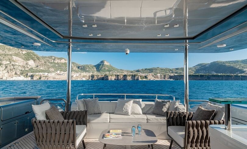 a patio with a table and chairs aboard SANDS Yacht for Charter