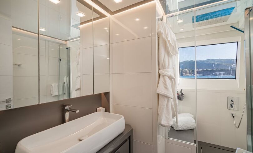 a bathroom with a large mirror aboard SANDS Yacht for Charter