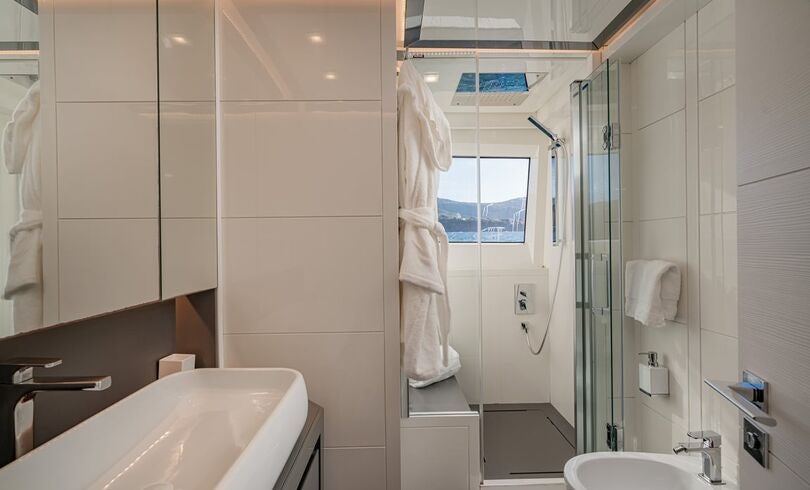 a bathroom with a shower unit and sink aboard SANDS Yacht for Charter