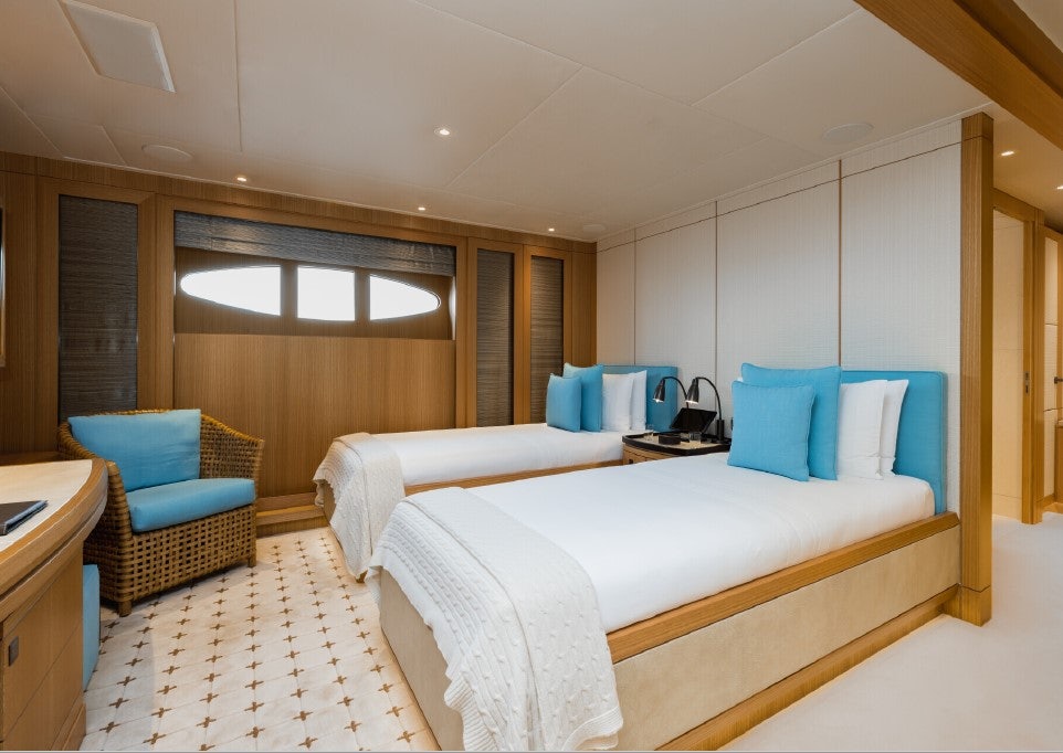 a room with a bed and a chair aboard VENTUM MARIS Yacht for Sale