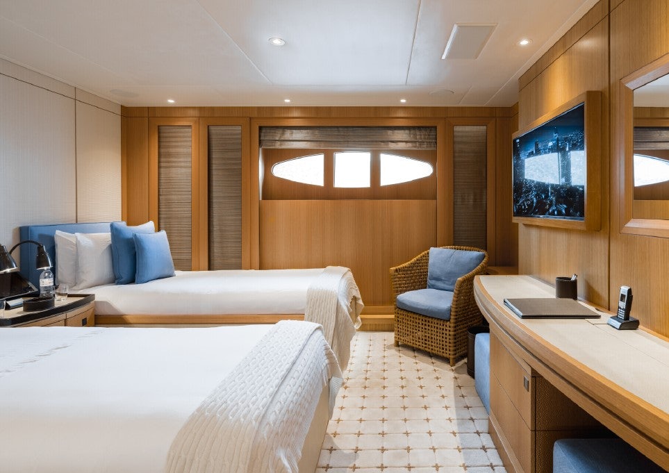 a room with a bed and a desk aboard VENTUM MARIS Yacht for Sale