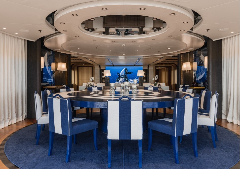 a large room with a table and chairs aboard VENTUM MARIS Yacht for Sale