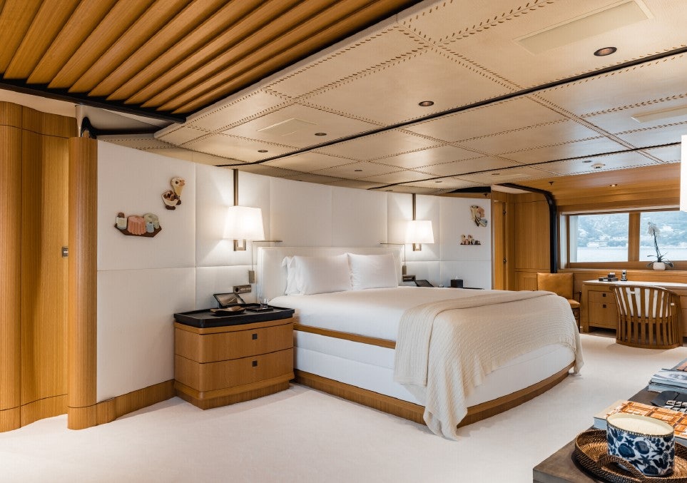 a bedroom with a bed and a table aboard VENTUM MARIS Yacht for Sale