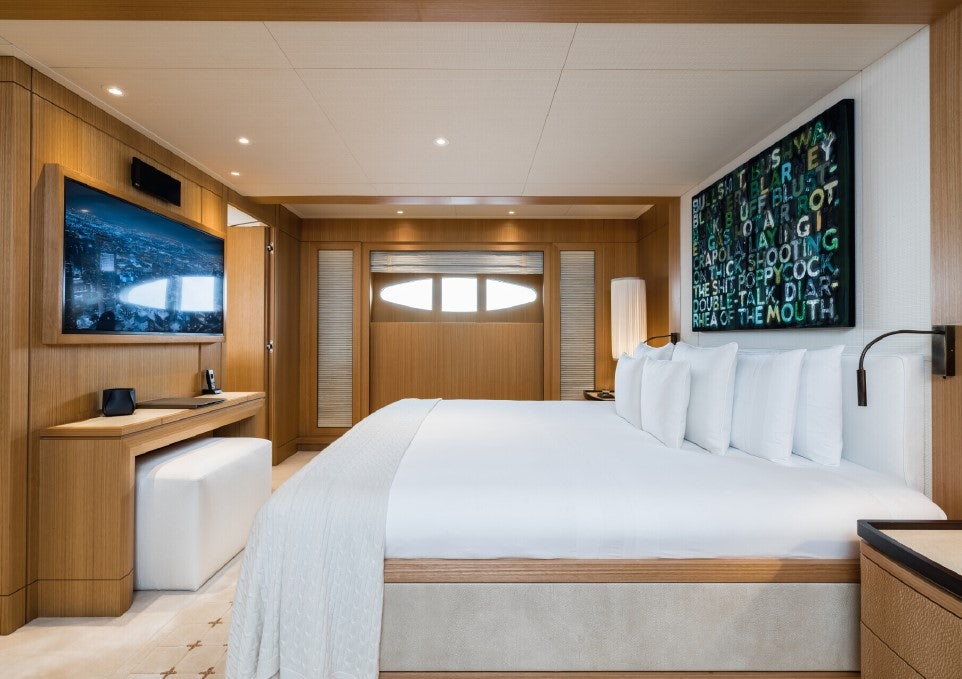 a bedroom with a bed and a desk aboard VENTUM MARIS Yacht for Sale
