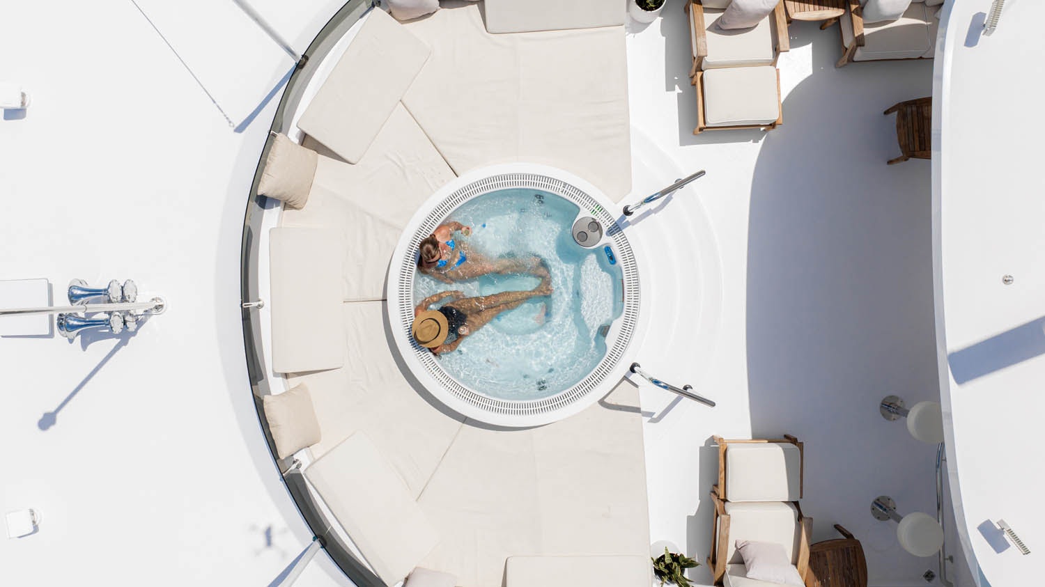 a white room with a painting on the wall and a chair aboard NICOLE EVELYN Yacht for Charter