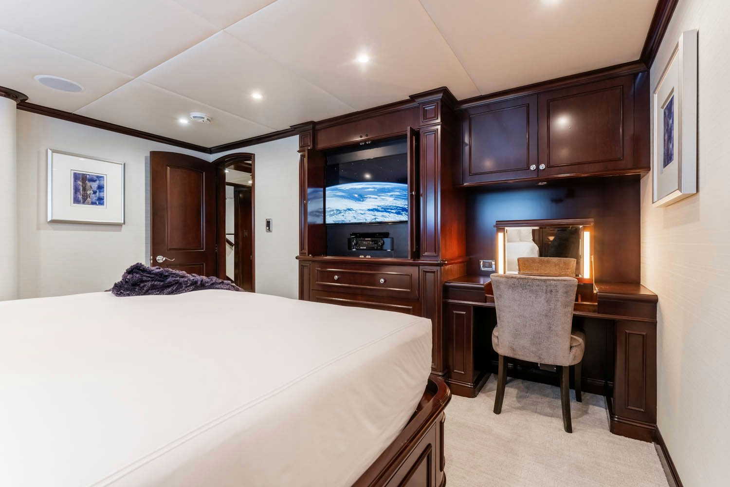 a bedroom with a bed and a desk aboard NICOLE EVELYN Yacht for Charter
