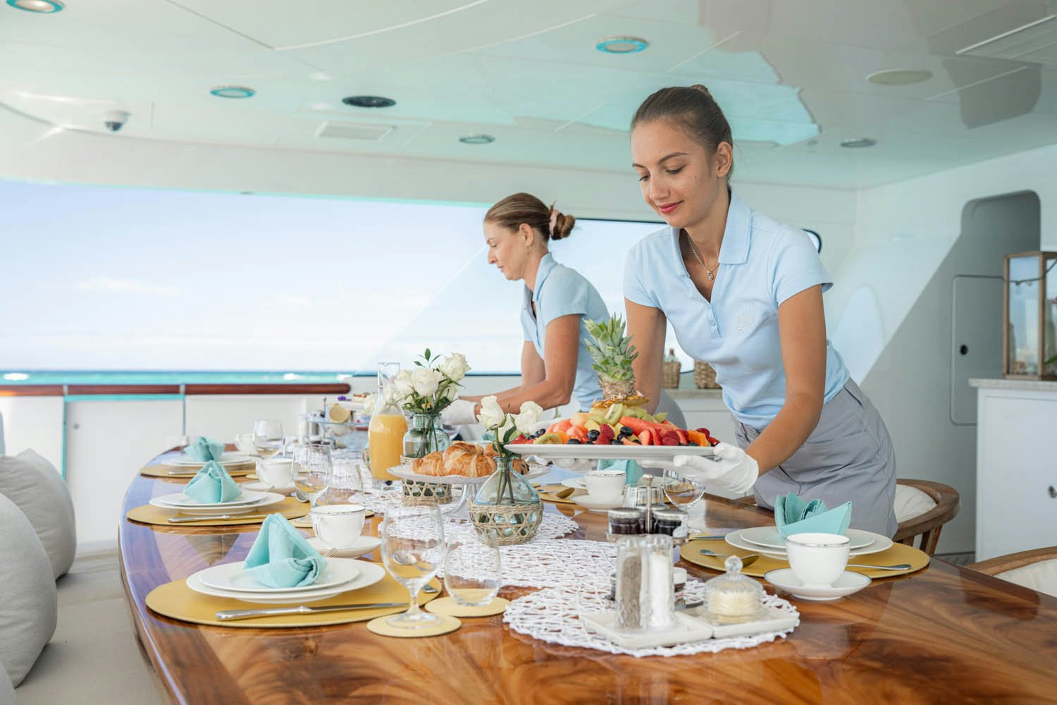 a couple of women preparing food aboard NICOLE EVELYN Yacht for Charter