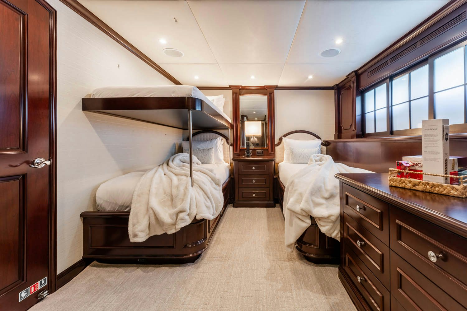 a room with a bed and a dresser aboard NICOLE EVELYN Yacht for Charter