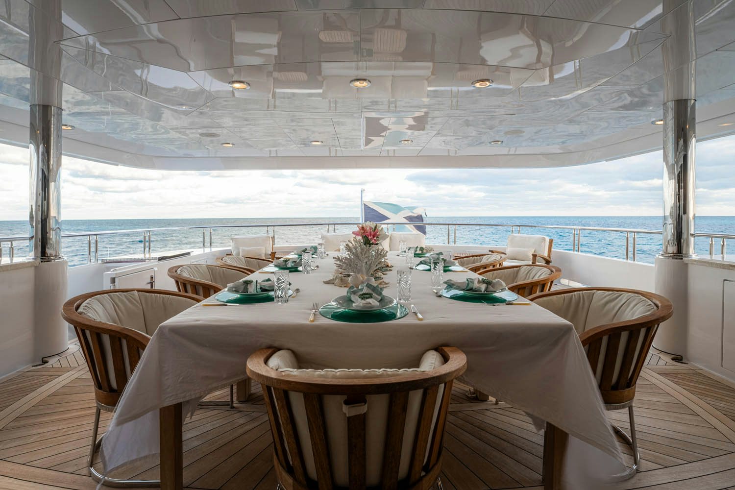 a table with chairs and a view of the ocean aboard NICOLE EVELYN Yacht for Charter