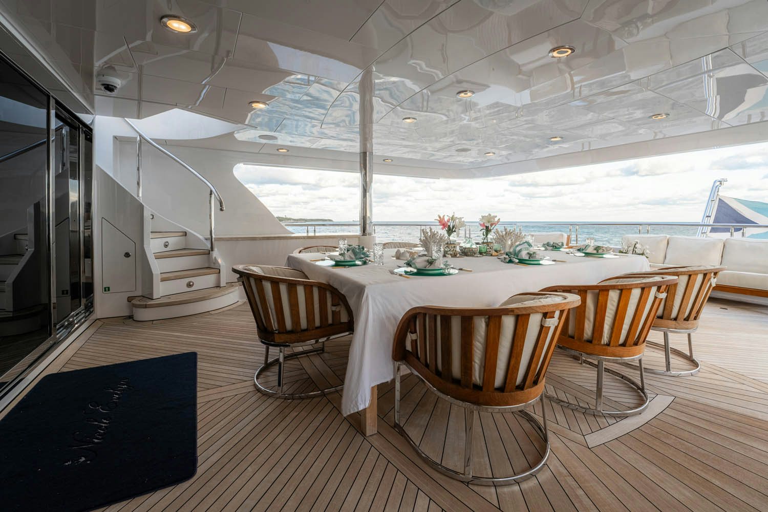 a room with a table chairs and a large window aboard NICOLE EVELYN Yacht for Charter