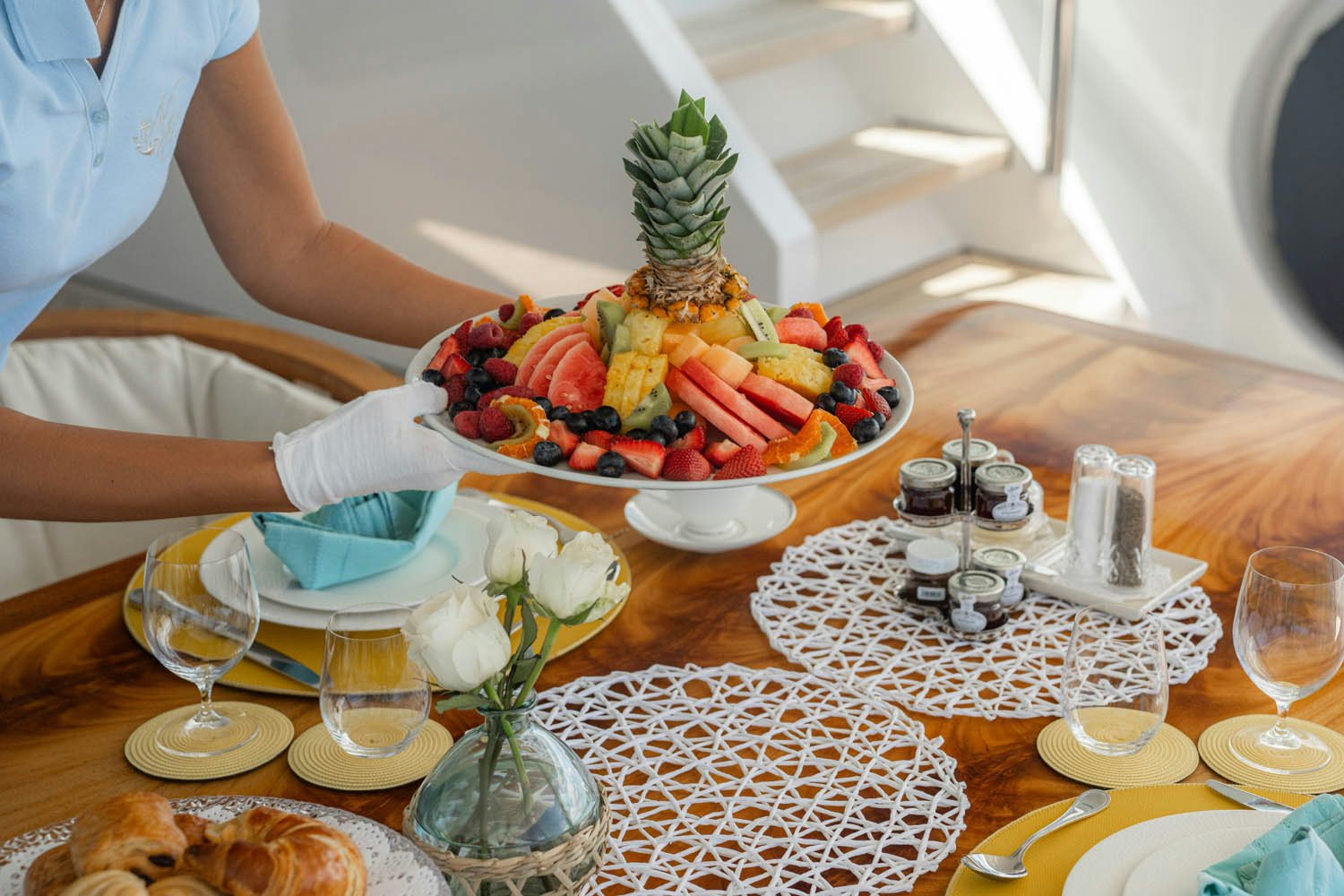 a person pouring a liquid into a glass aboard NICOLE EVELYN Yacht for Charter