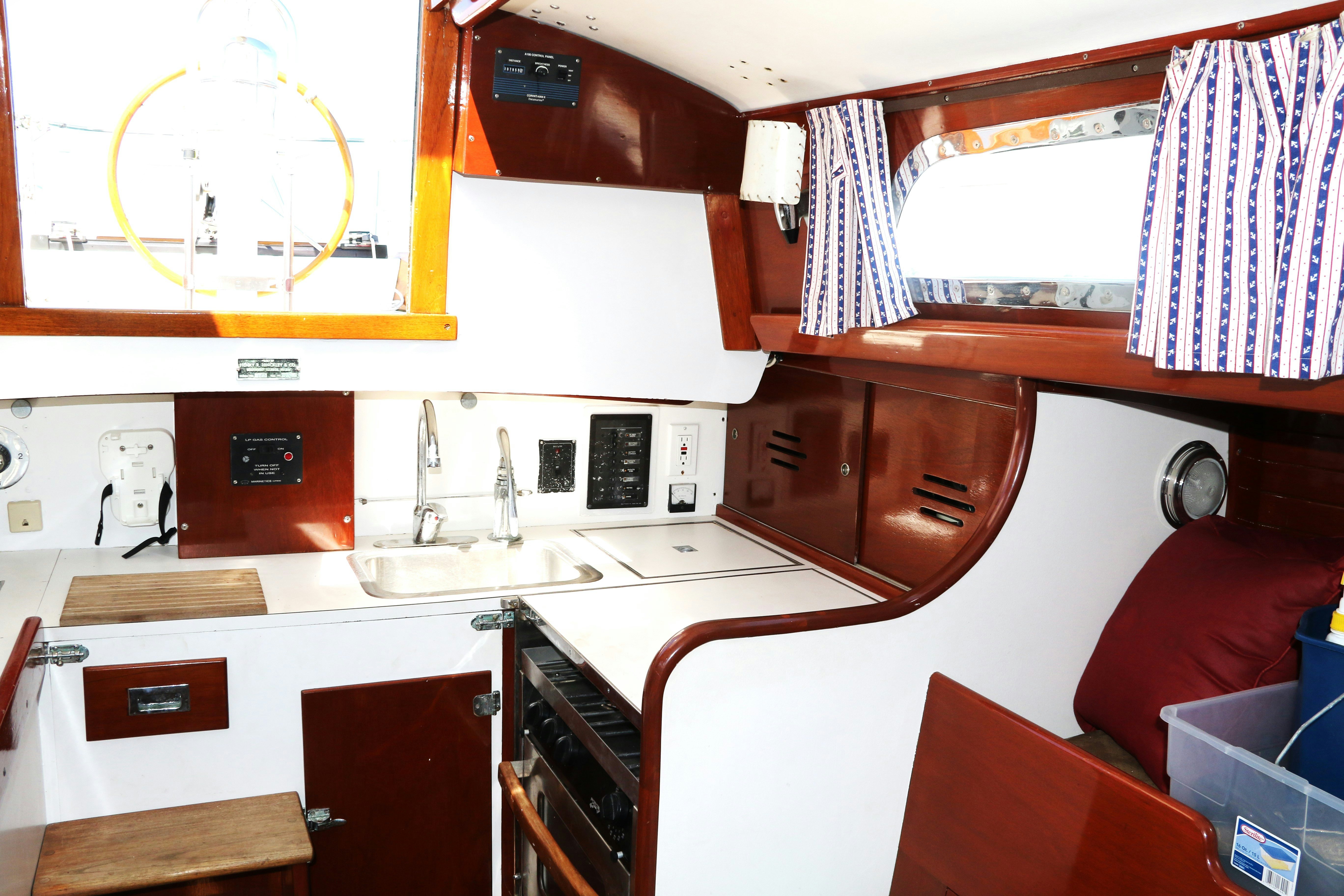 a kitchen with red cabinets aboard ESOTERIC Yacht for Sale