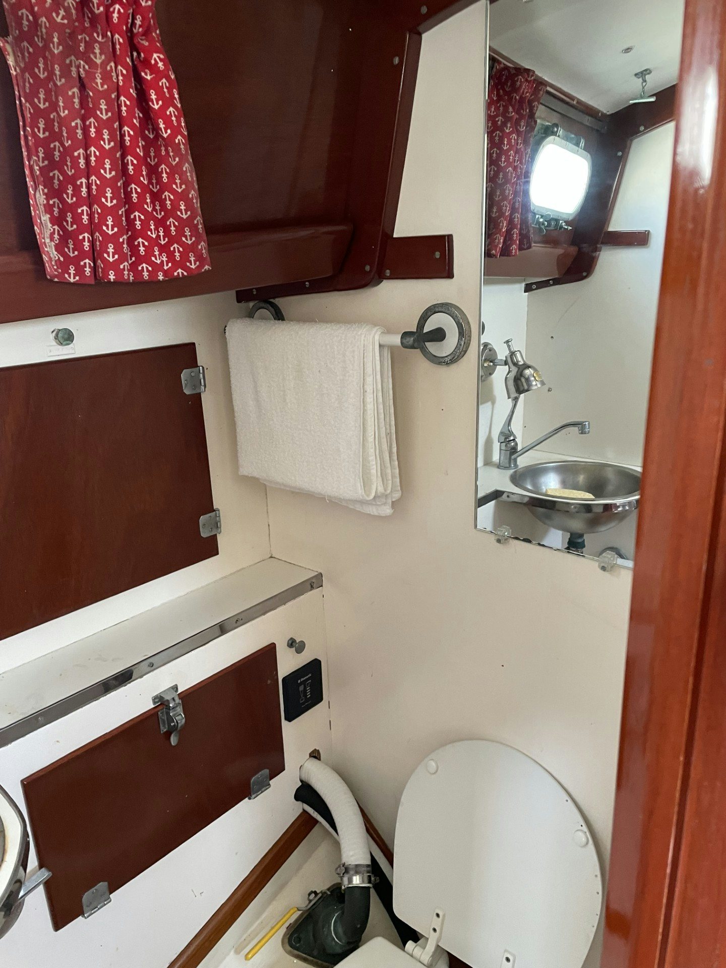 a bathroom with red curtains aboard ESOTERIC Yacht for Sale