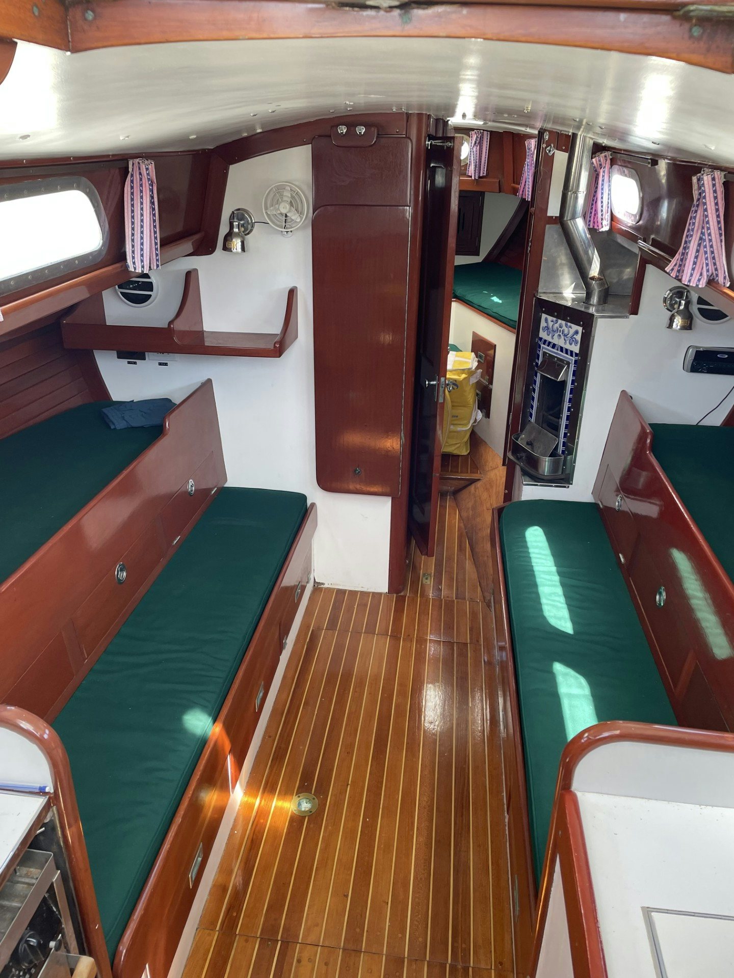 a room with a green and red bunk bed and a yellow and blue rug aboard ESOTERIC Yacht for Sale