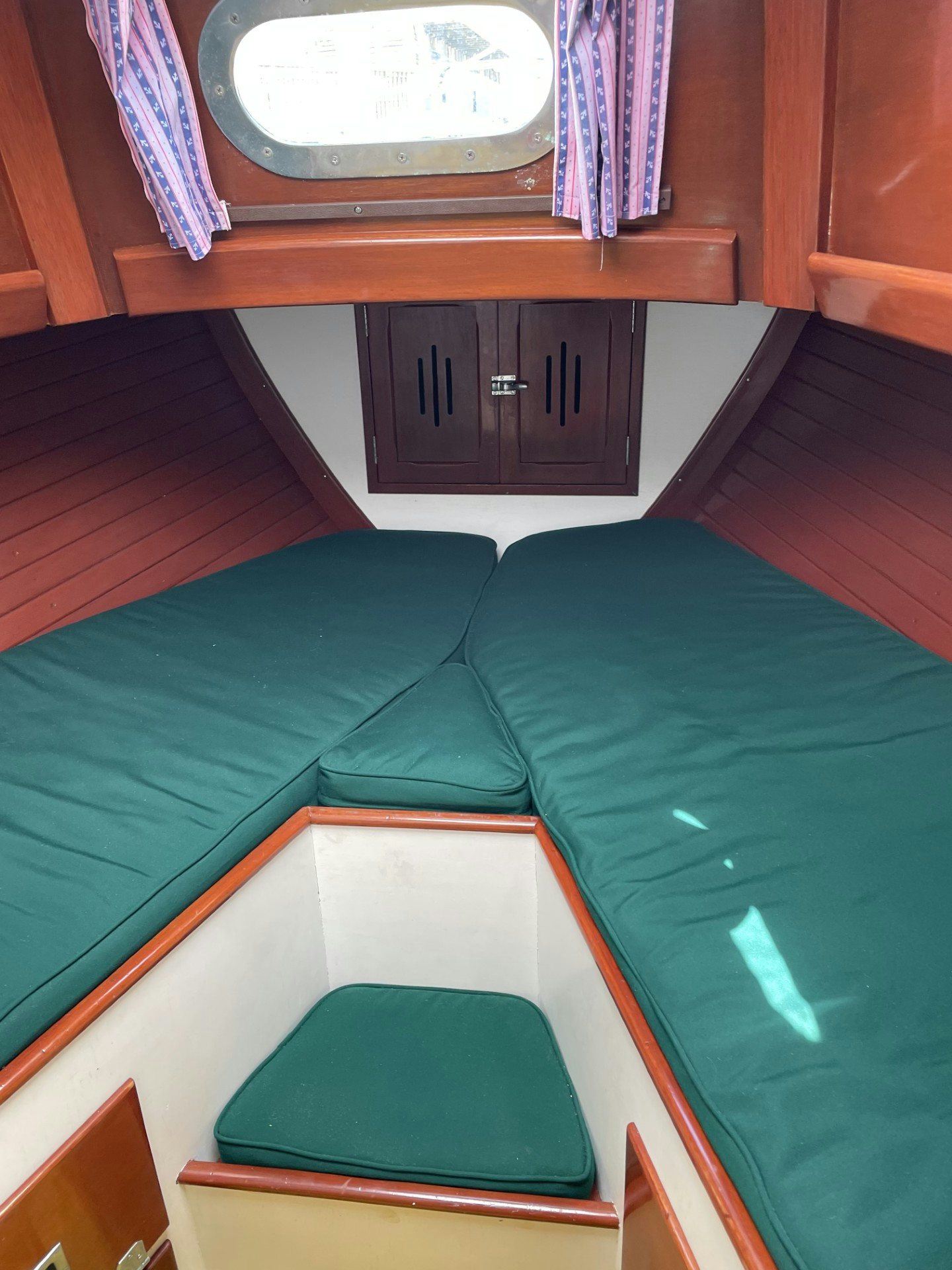 a green couch with a black rectangular object on it aboard ESOTERIC Yacht for Sale
