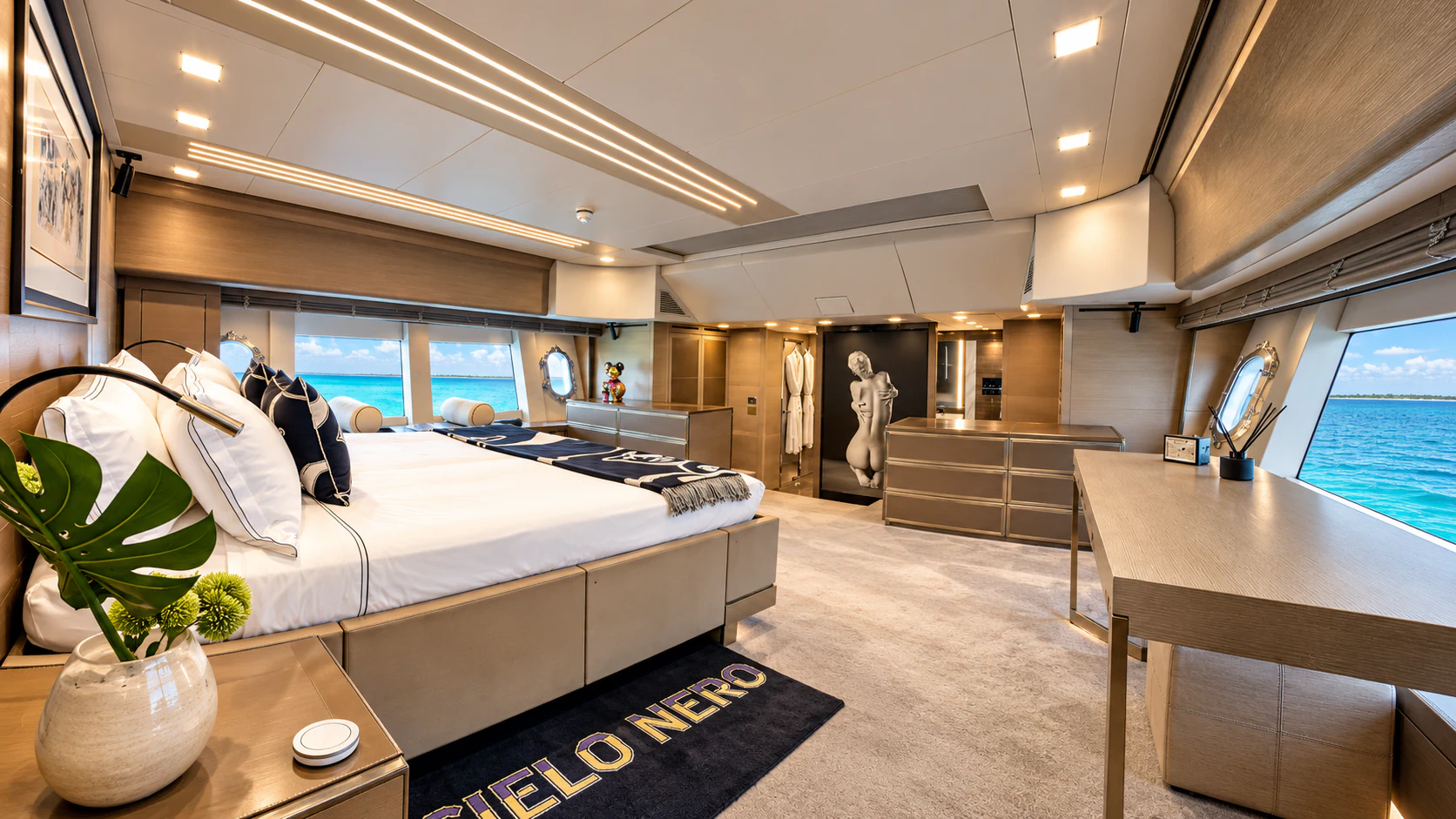 a room with a bed and a desk aboard CIELO NERO Yacht for Charter