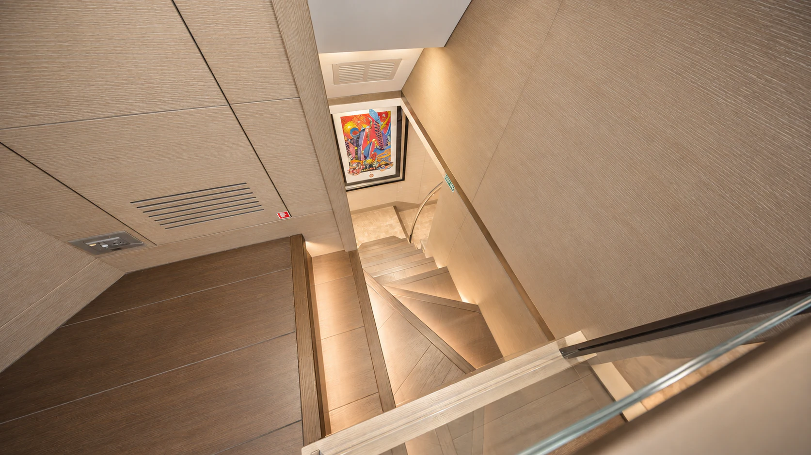 a staircase with a painting on the wall aboard CIELO NERO Yacht for Charter