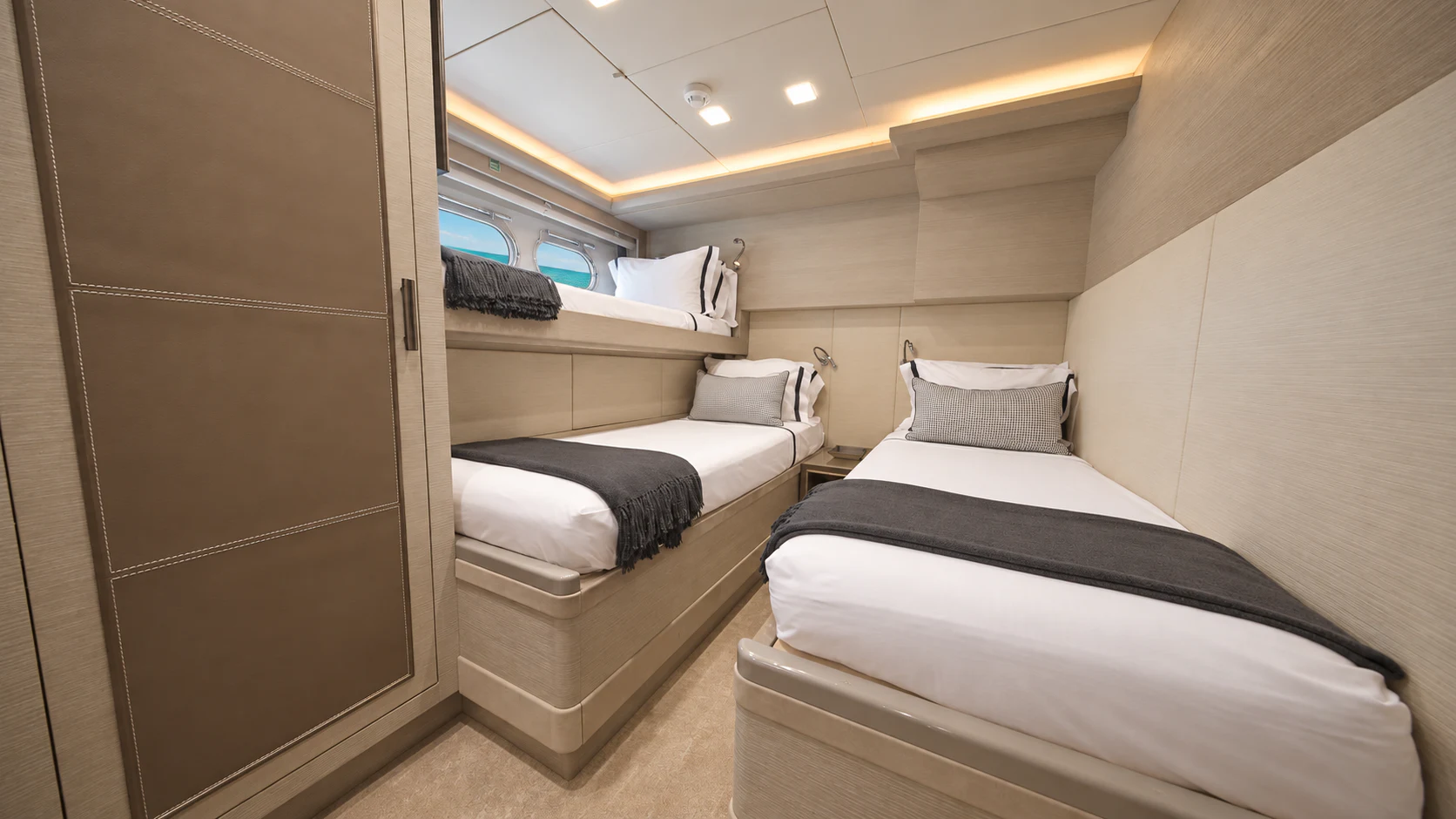 a room with beds and a window aboard CIELO NERO Yacht for Charter