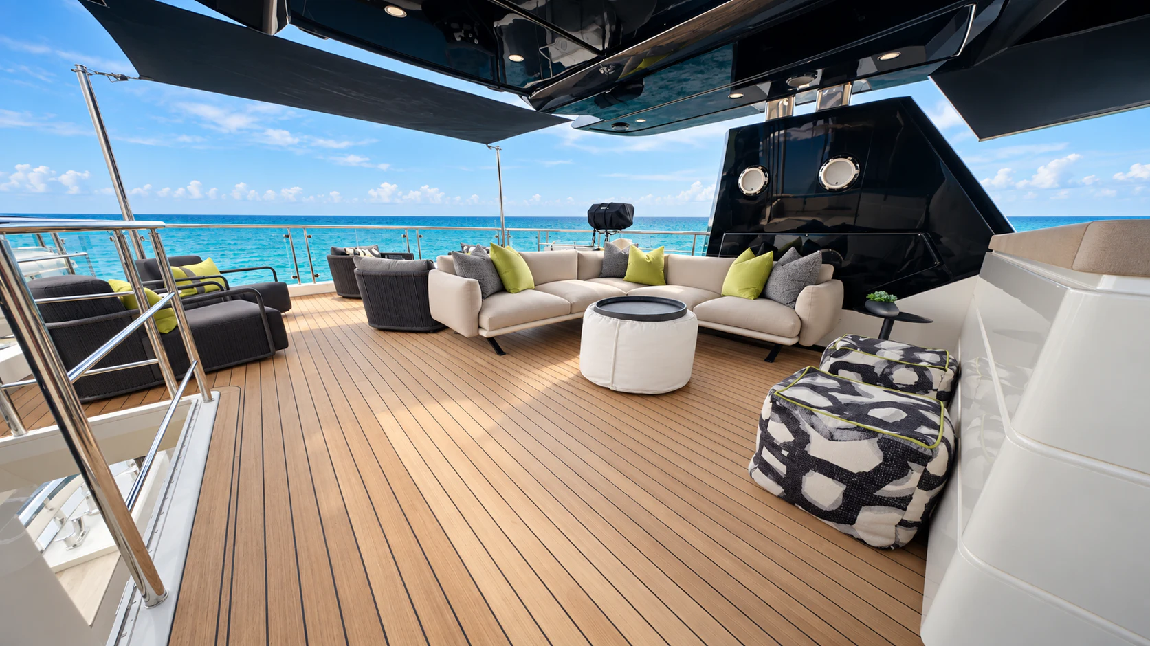 a deck with a large sofa and a large black piano on it aboard CIELO NERO Yacht for Charter