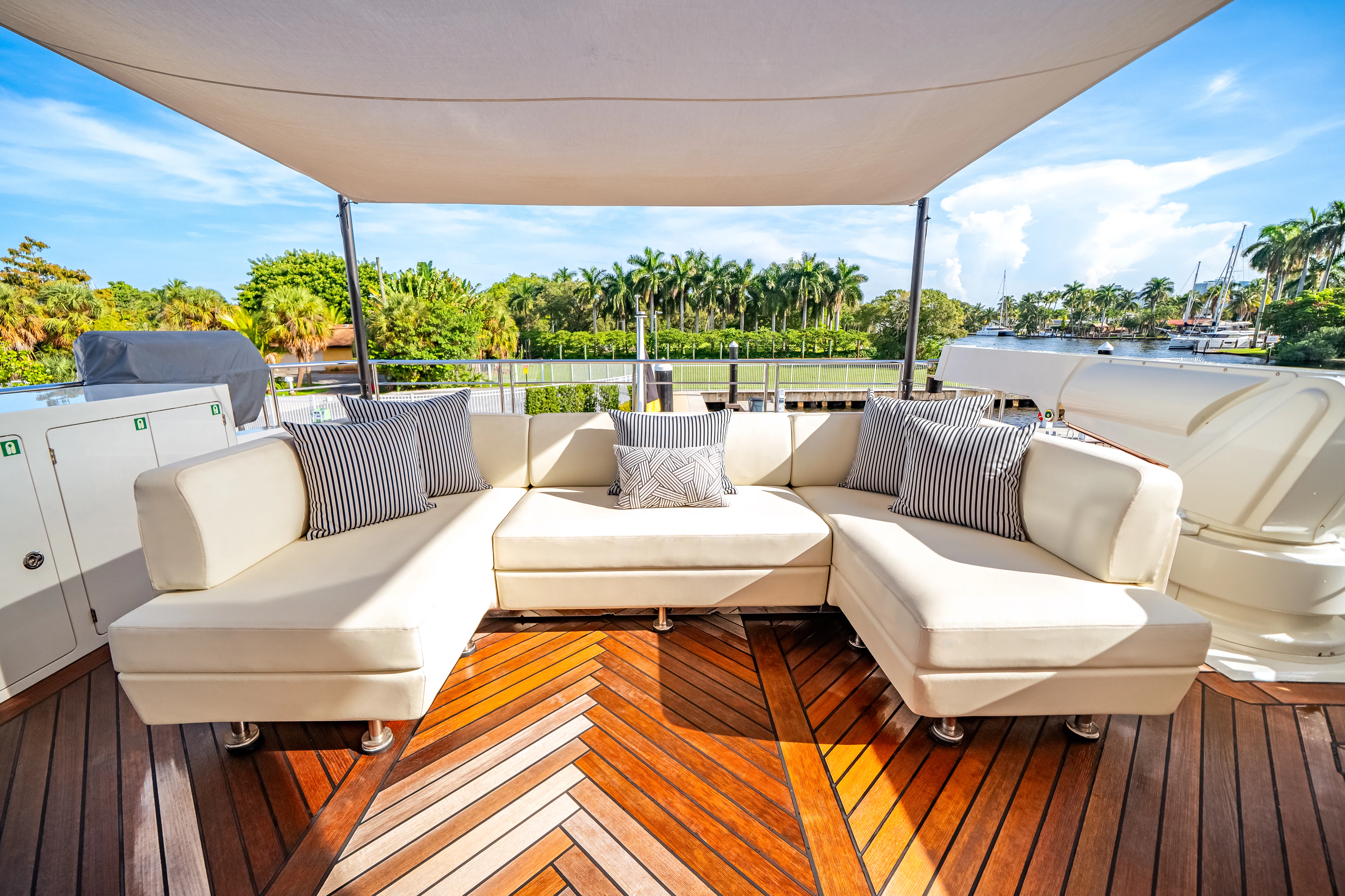 a large white couch sits on a deck aboard JUST A VACATION Yacht for Sale