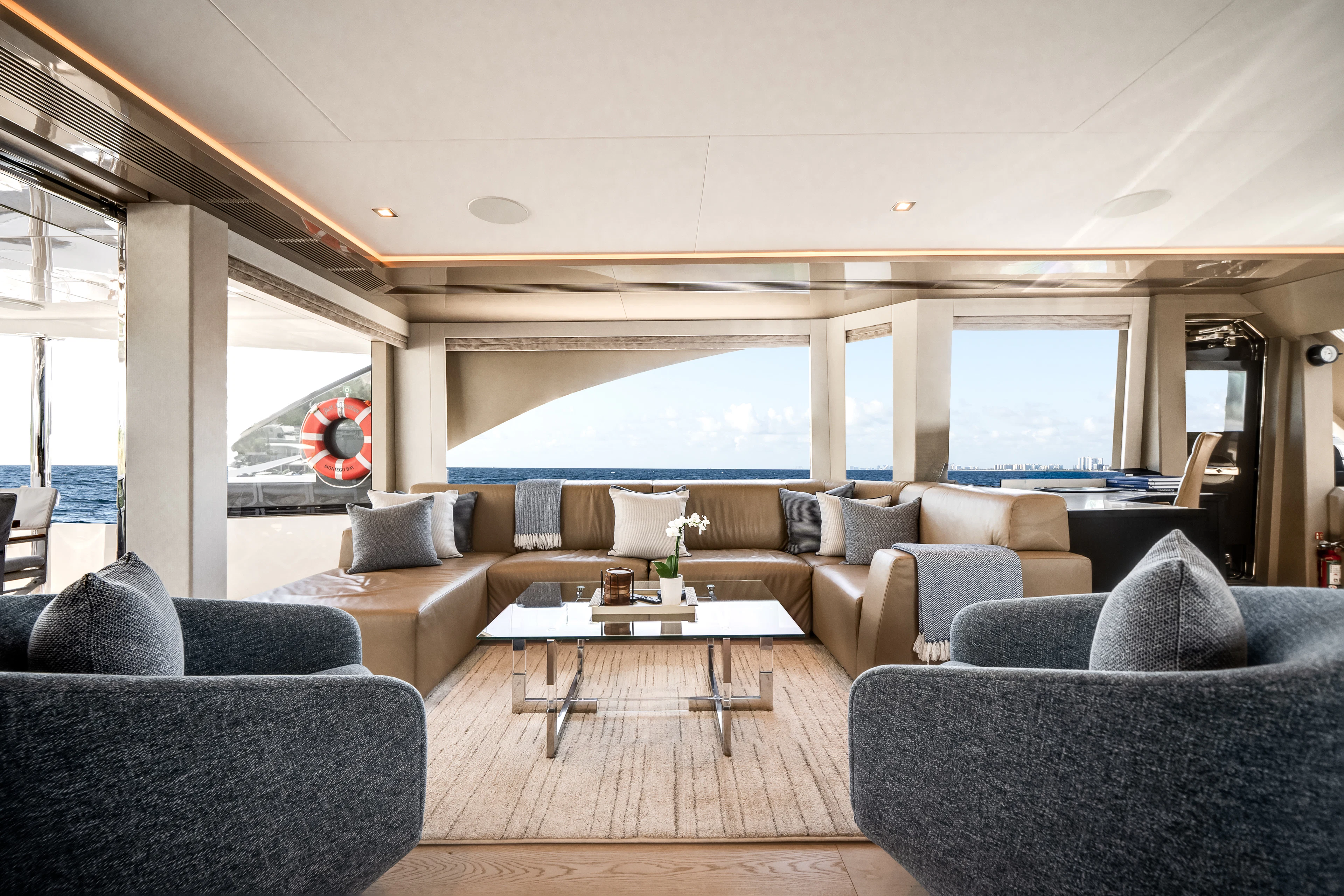a living room with a large window aboard JUST A VACATION Yacht for Sale