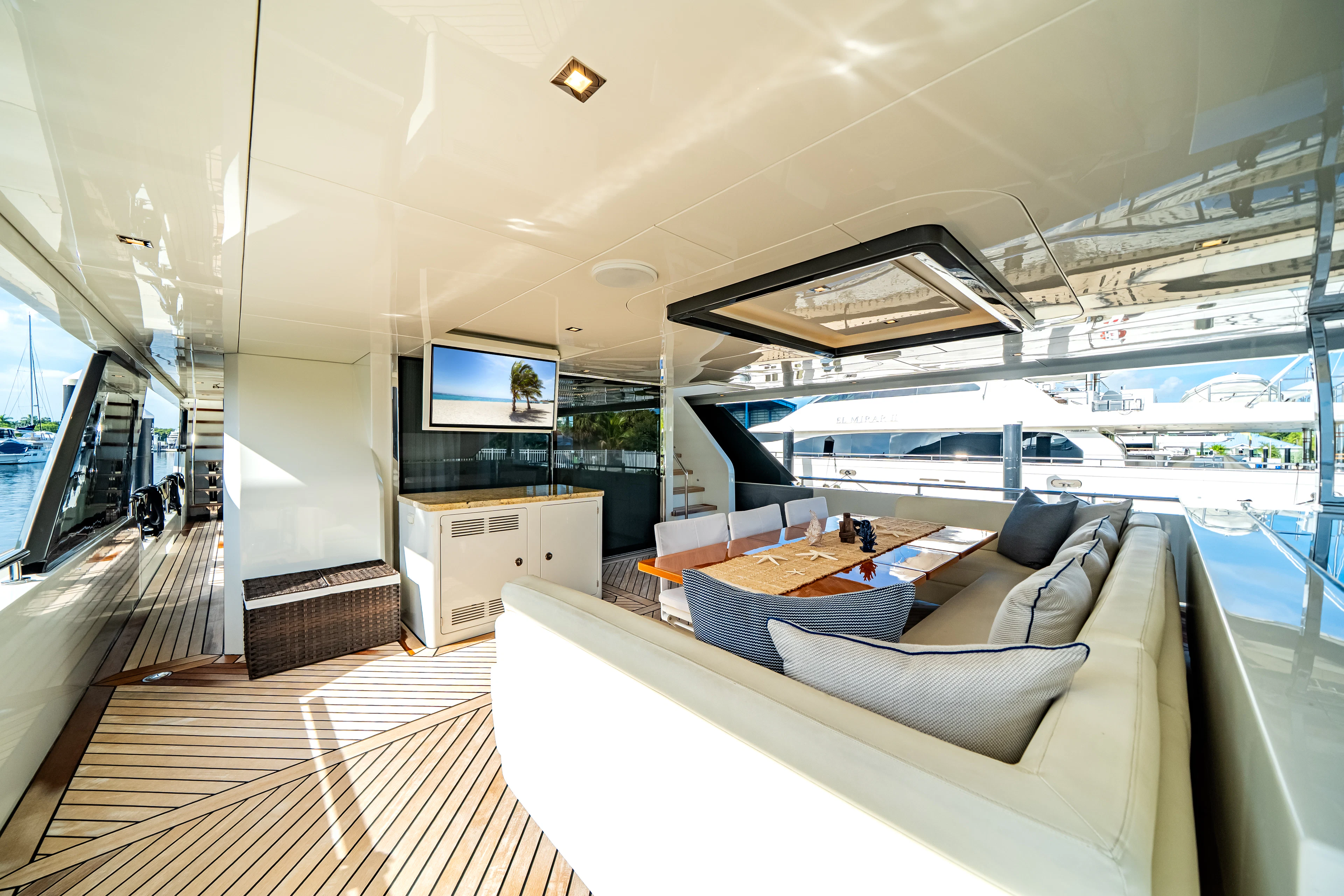 a room with a large window and a large deck with a large pool aboard JUST A VACATION Yacht for Sale