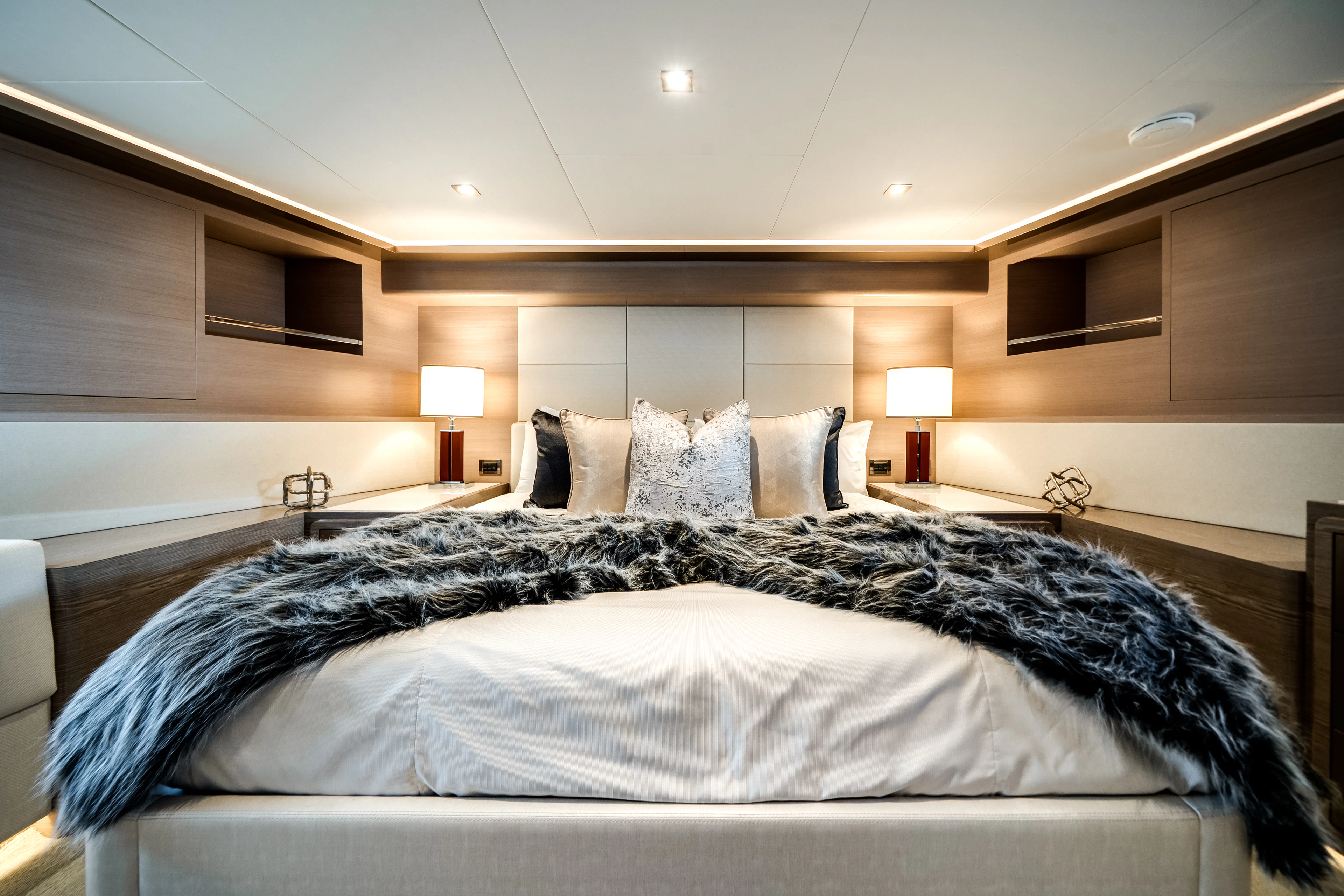 a bed with a white bed spread aboard JUST A VACATION Yacht for Sale