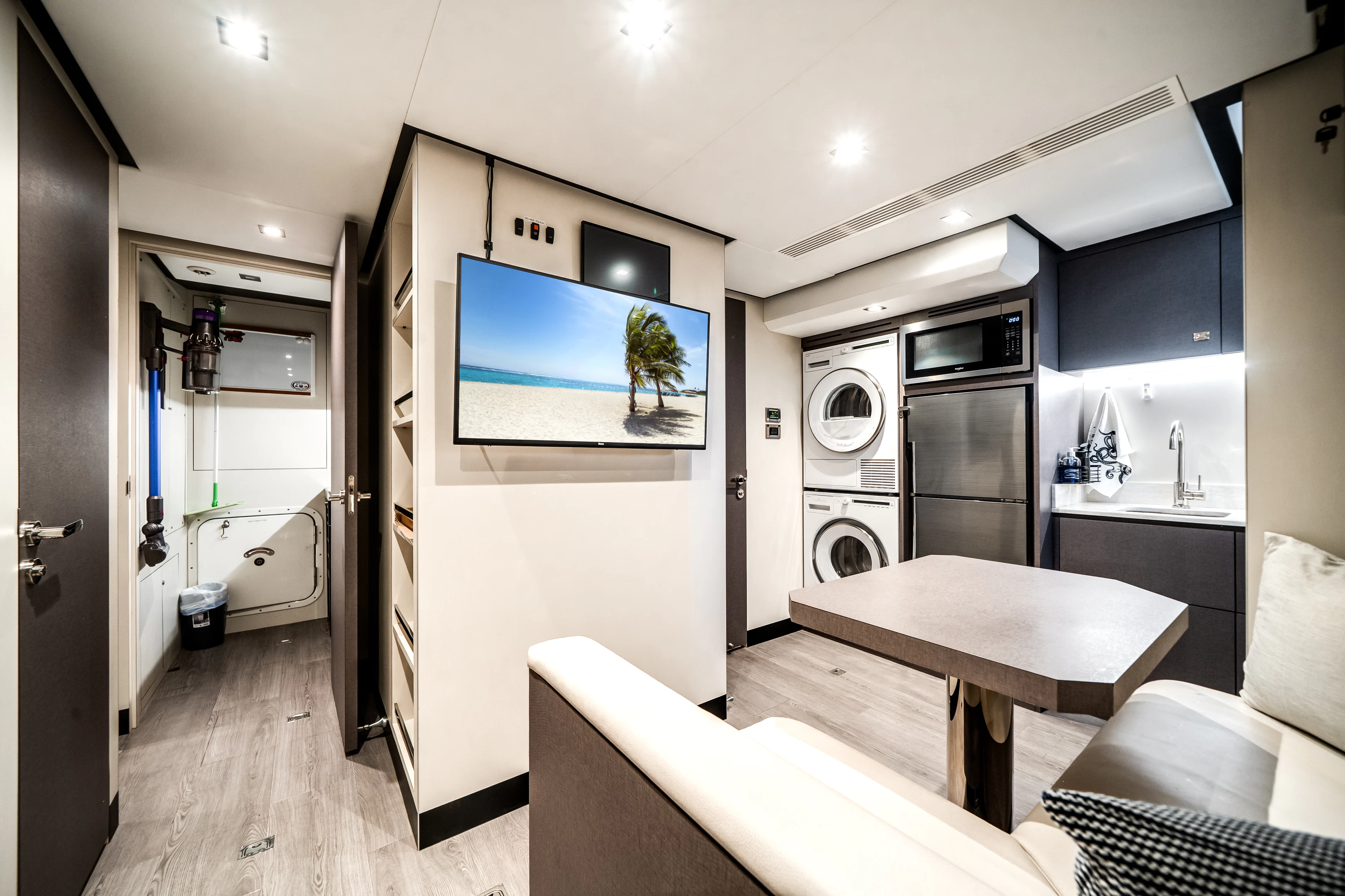 a room with a table and couch aboard JUST A VACATION Yacht for Sale