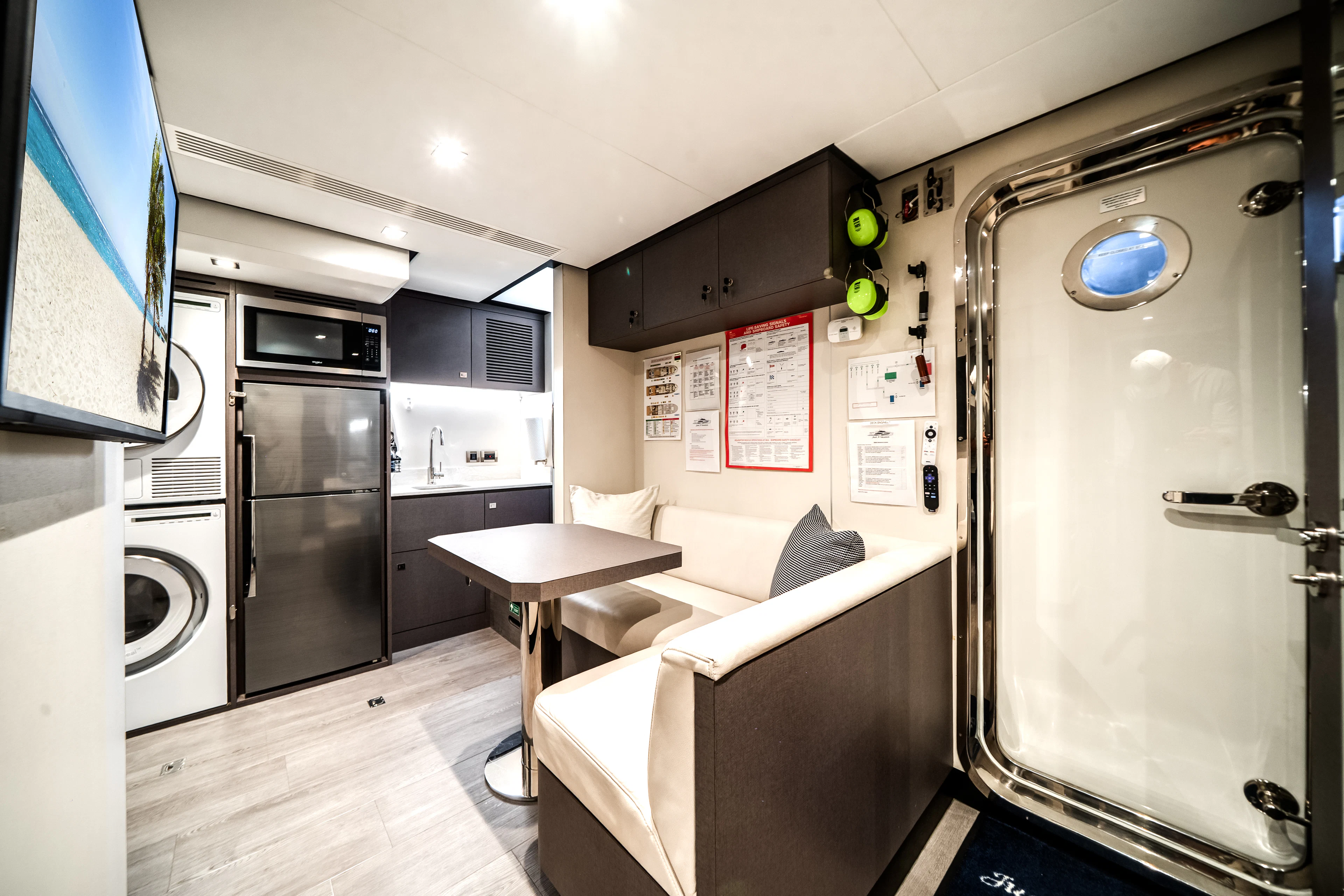a kitchen with a table and refrigerator aboard JUST A VACATION Yacht for Sale