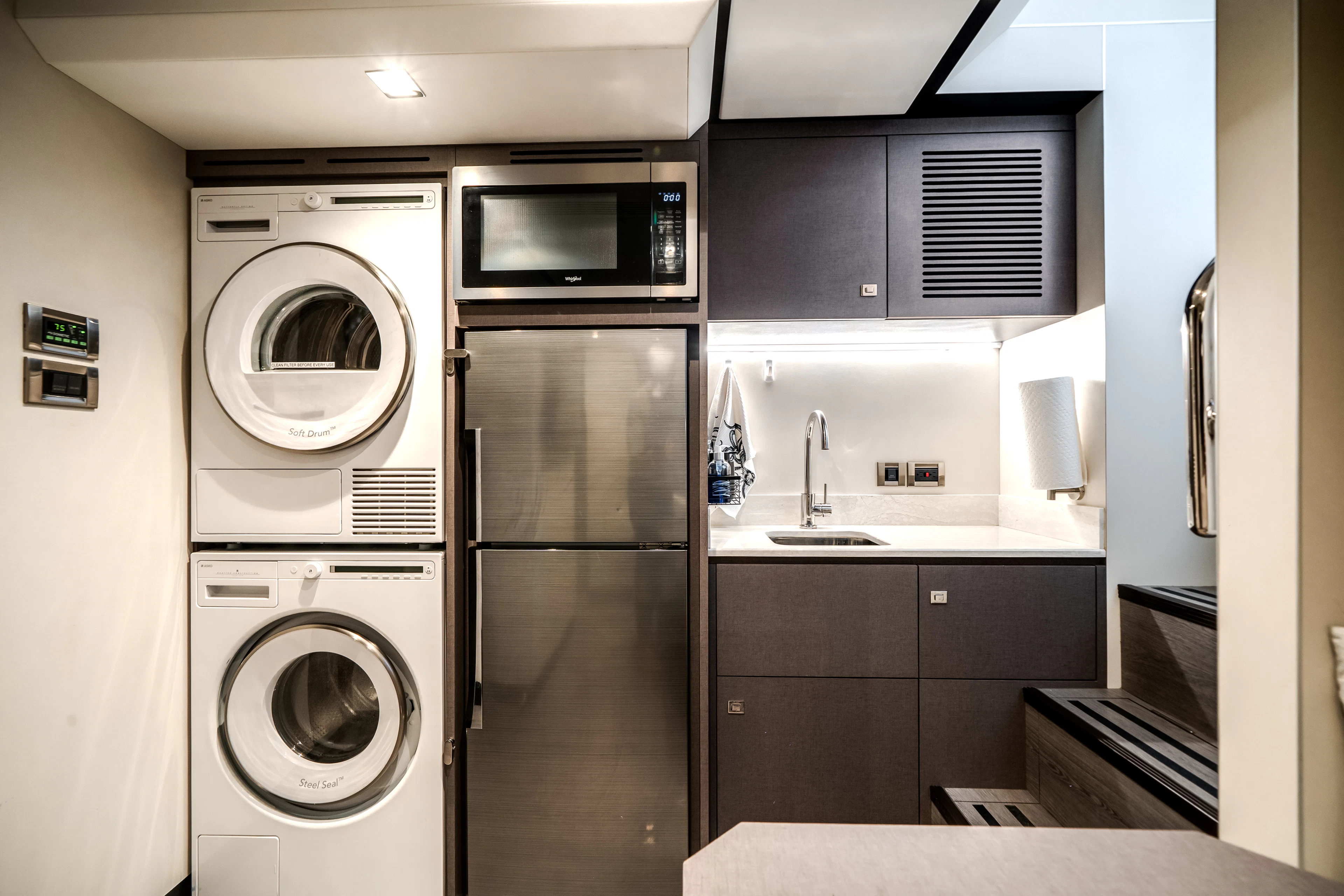 a kitchen with a washing machine and a sink aboard JUST A VACATION Yacht for Sale