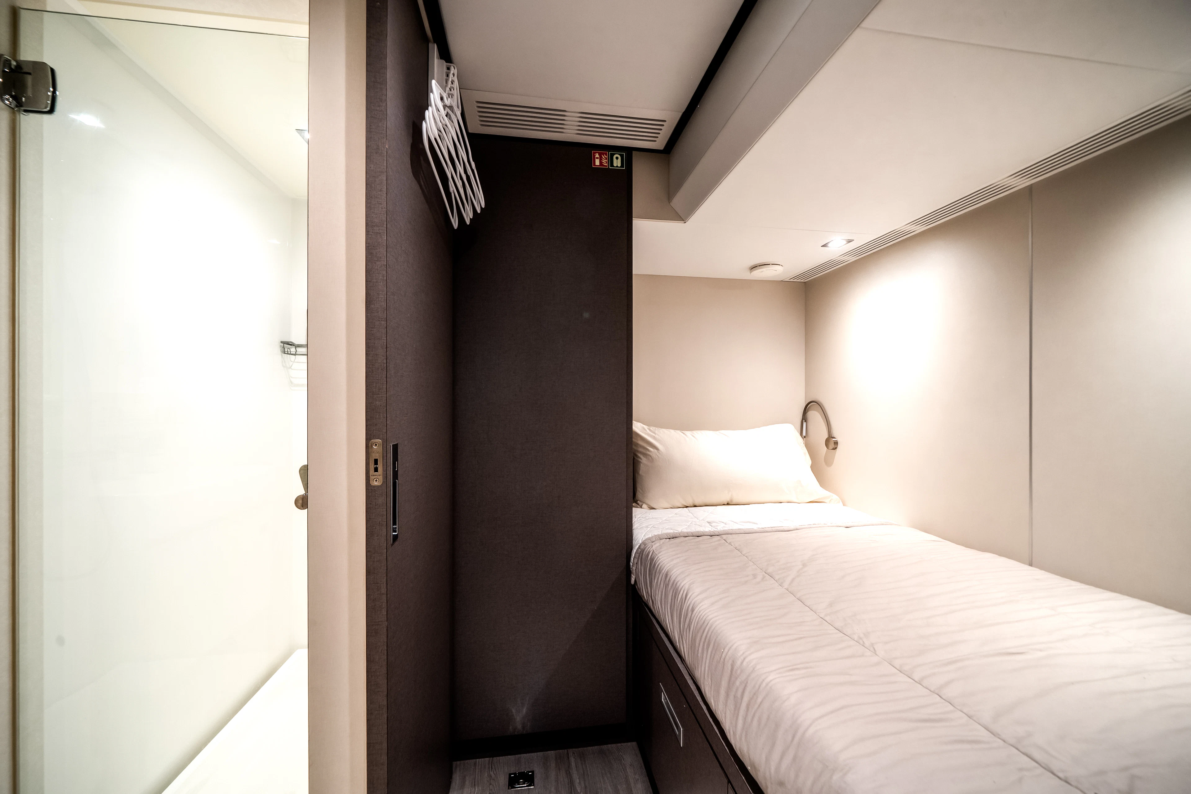a room with a bed and a door aboard JUST A VACATION Yacht for Sale