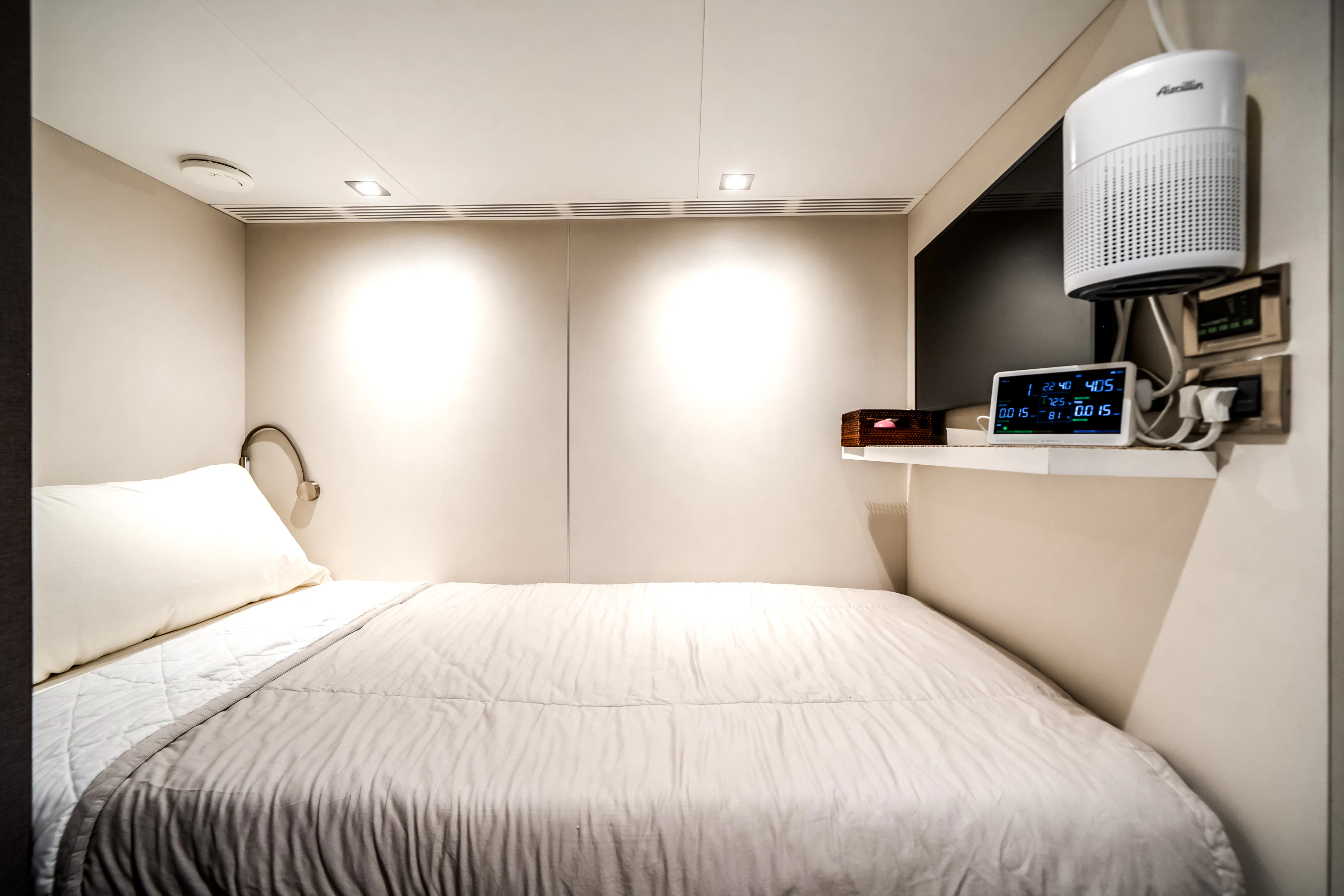 a bed with a white bed spread aboard JUST A VACATION Yacht for Sale