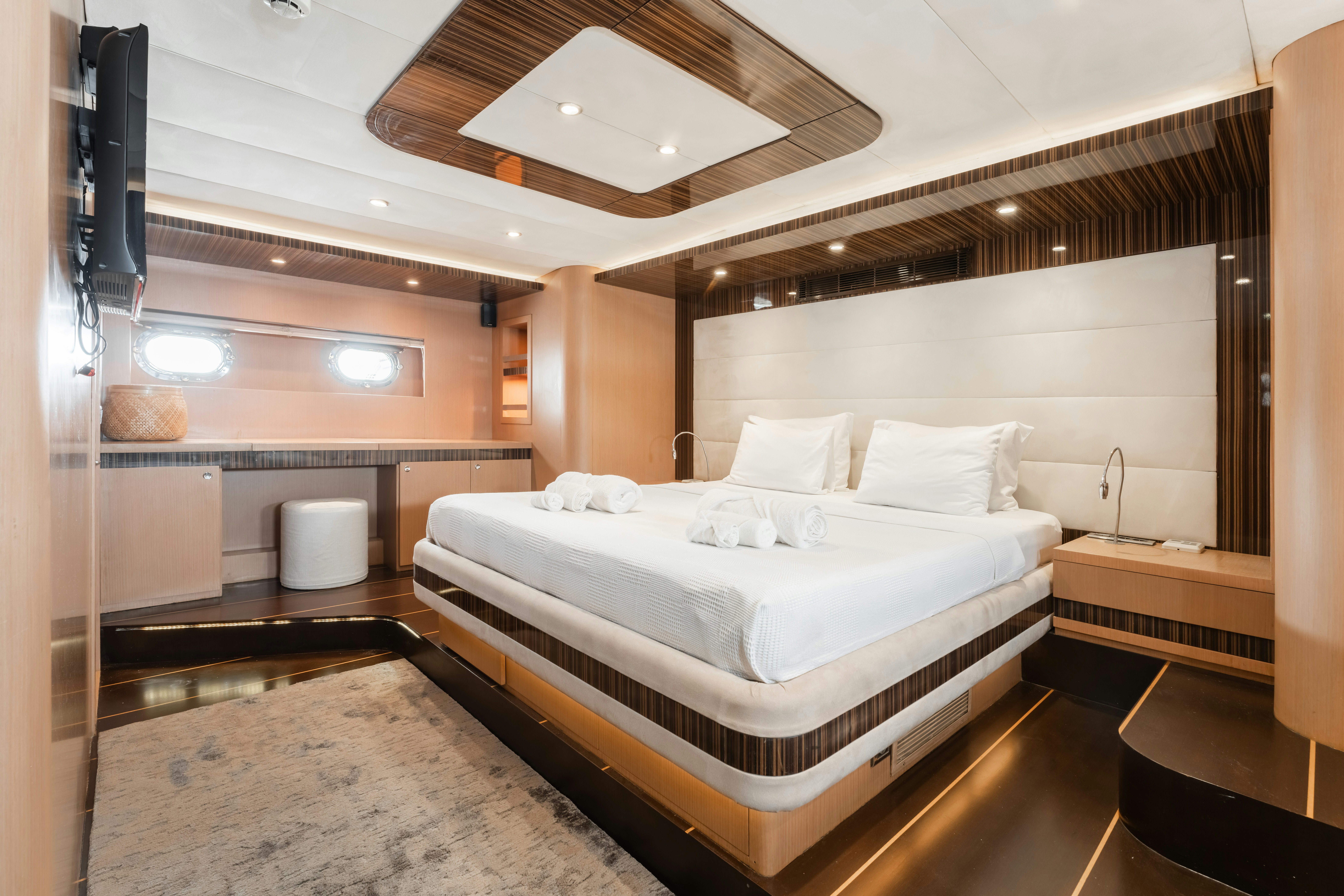 a room with a bed and a large mirror aboard LE PIETRE Yacht for Sale