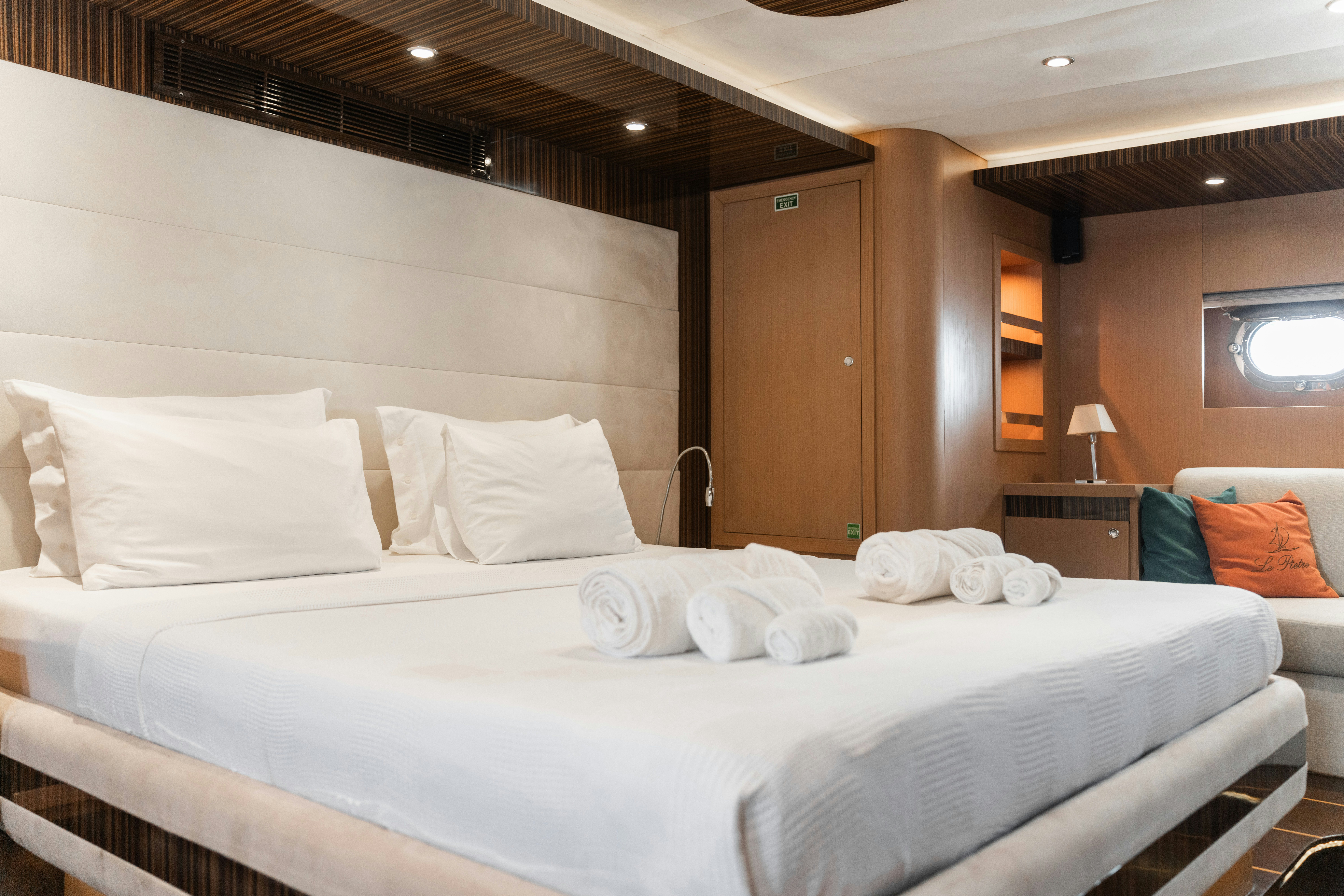 a room with a bed and a desk aboard LE PIETRE Yacht for Sale