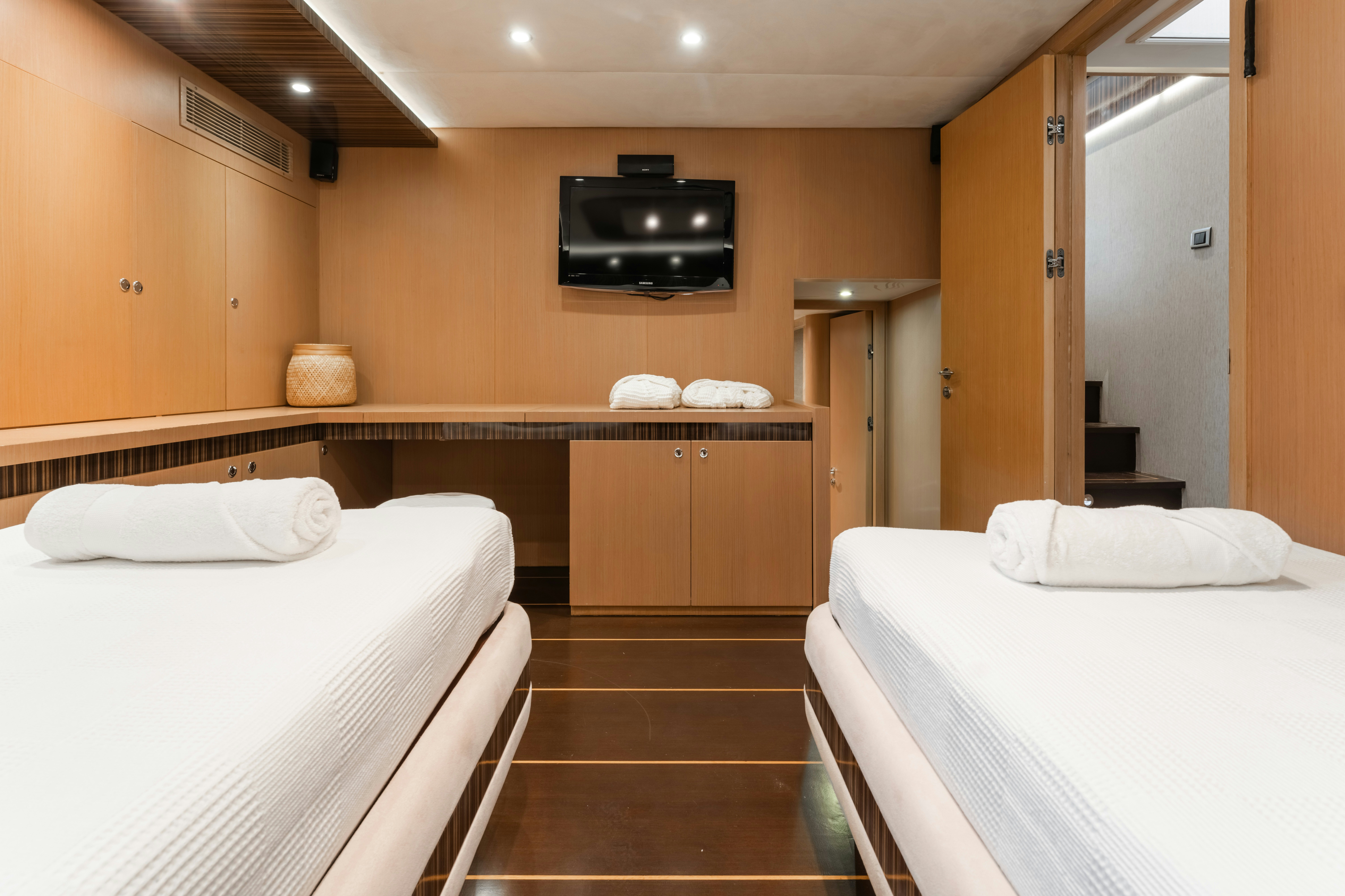 a room with beds and a tv aboard LE PIETRE Yacht for Sale