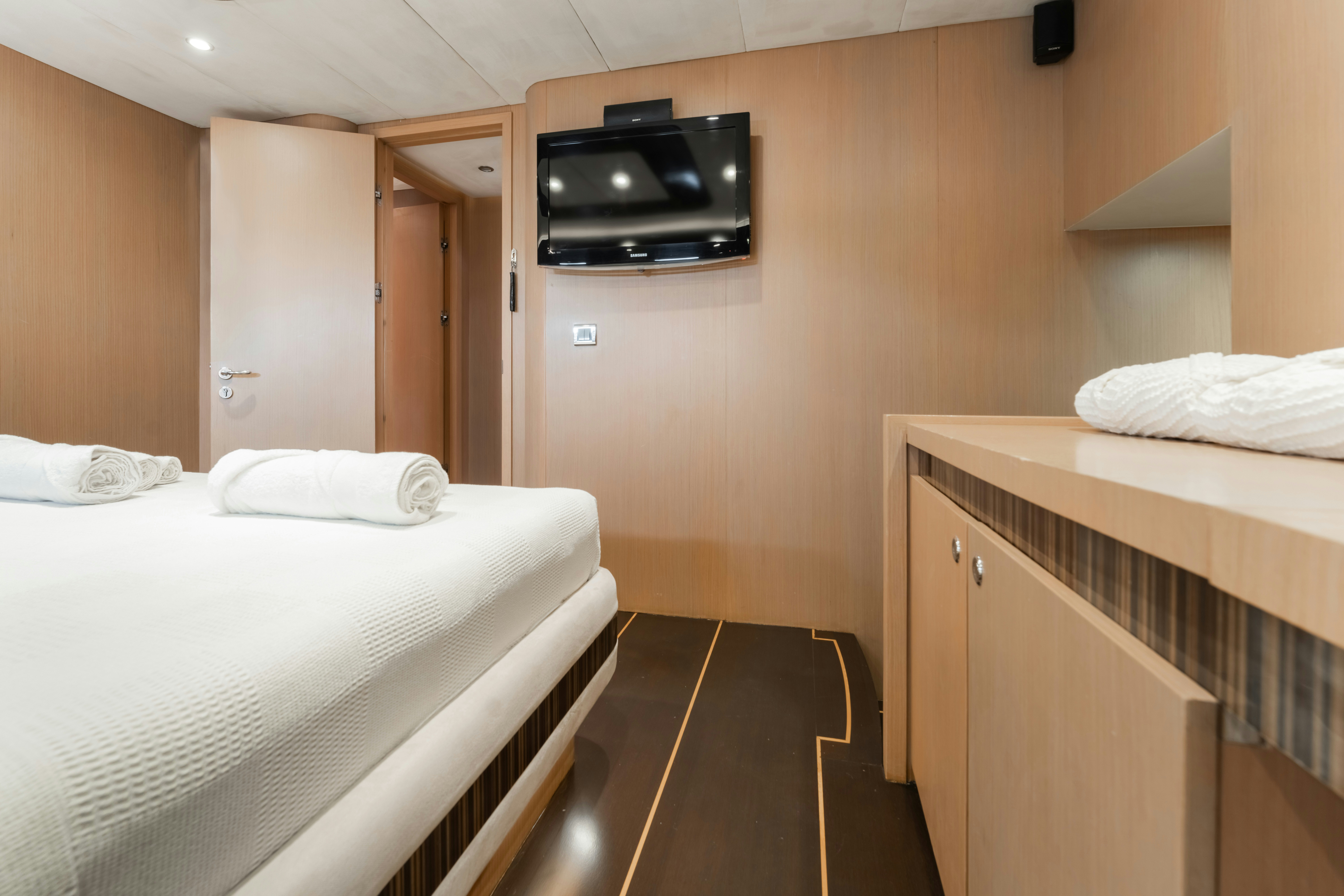 a hotel room with a tv on the wall aboard LE PIETRE Yacht for Sale