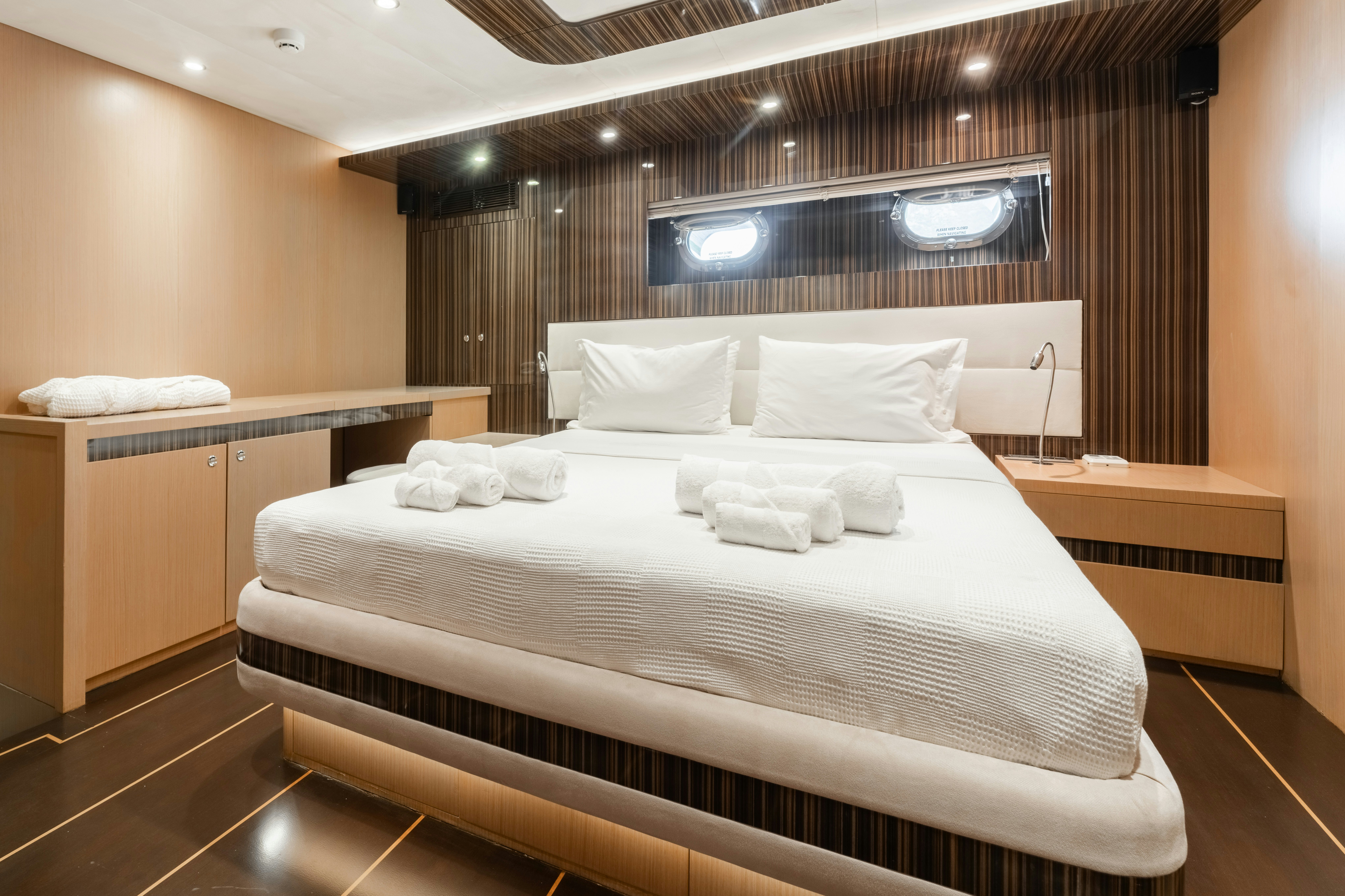 a bed with white sheets aboard LE PIETRE Yacht for Sale