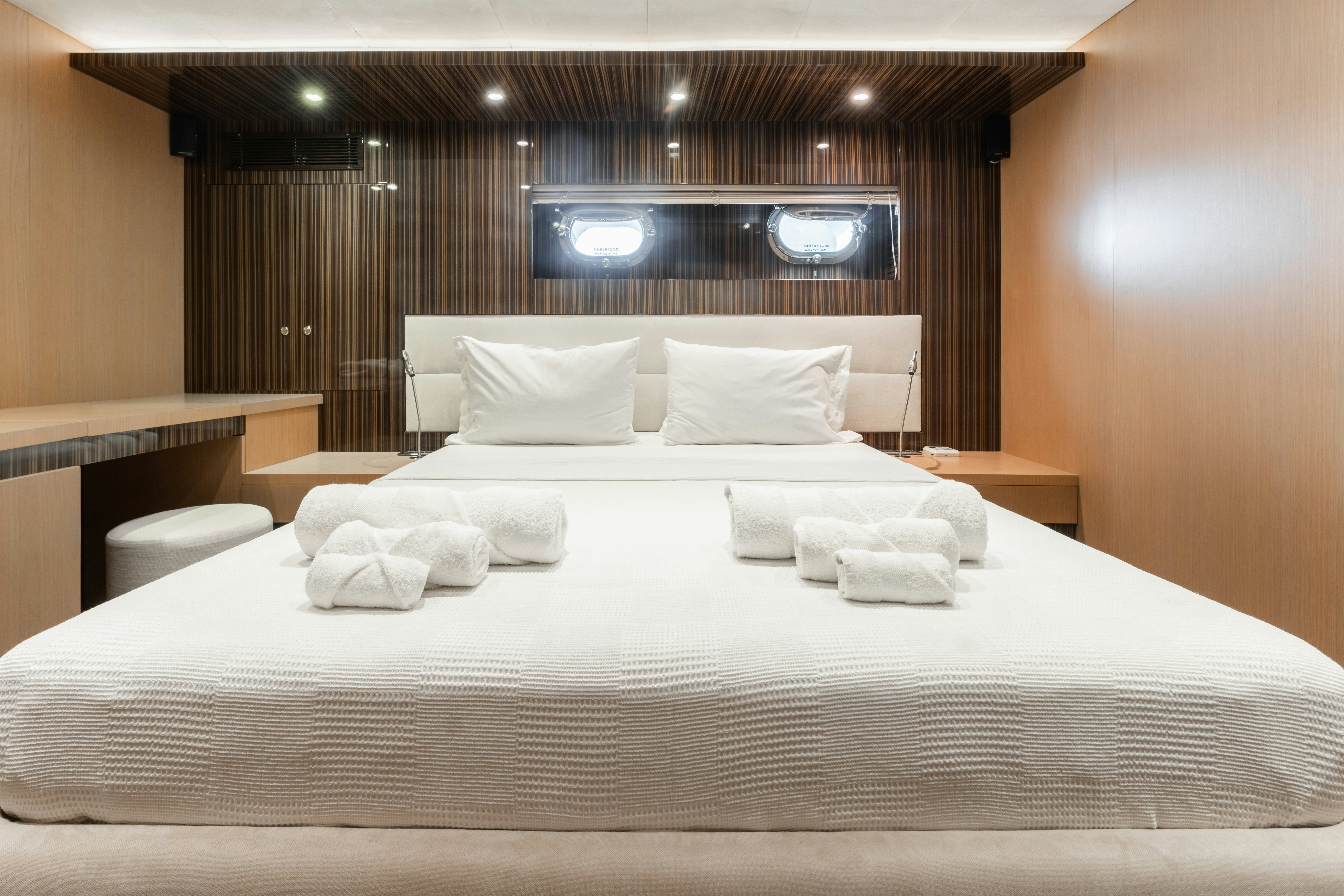 a bed with white sheets aboard LE PIETRE Yacht for Sale